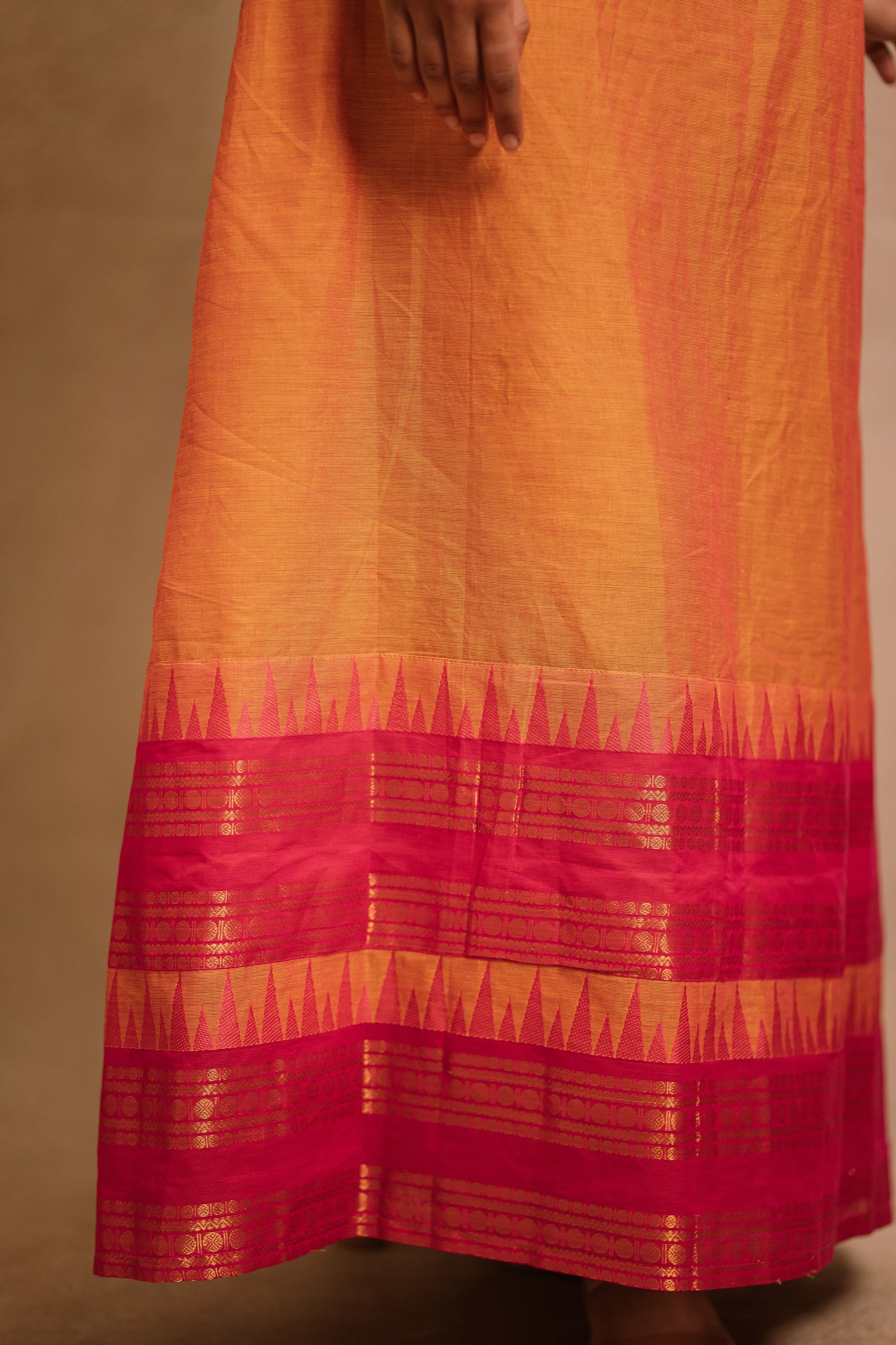 Border of an A-line sleeveless dress in orange (dual tone fabric) by team AKloset.