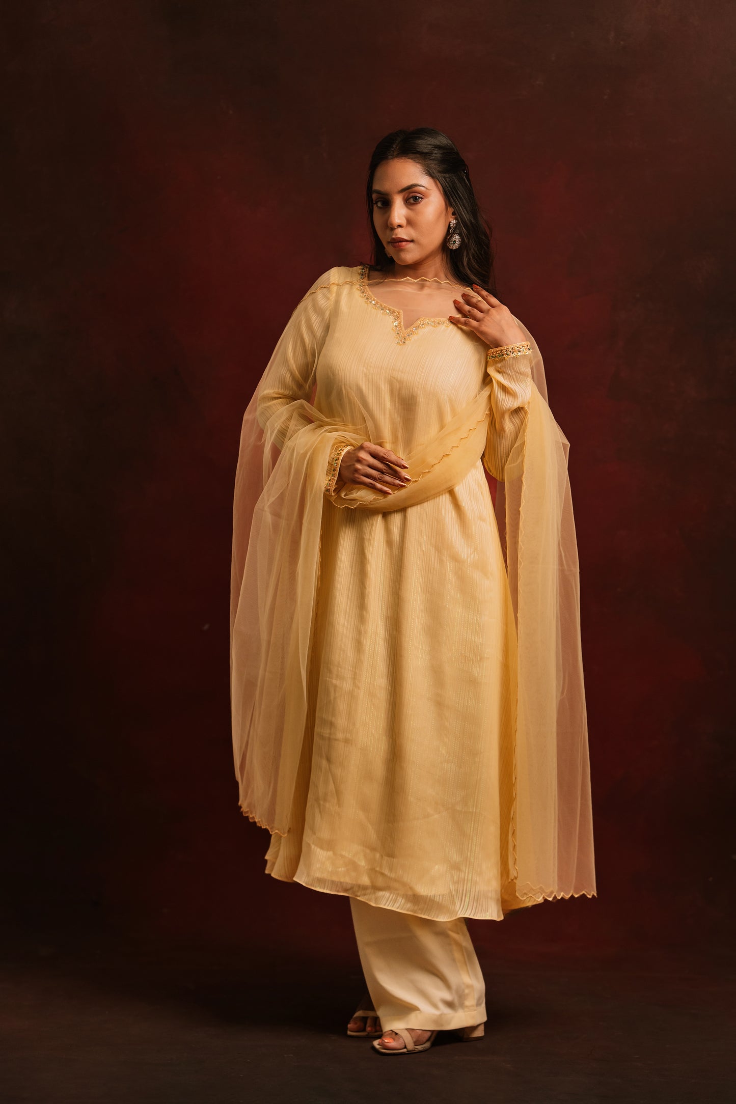 Model Dolly Aishwarya in a hand embroidered chiffon salwar set in yellow paired with a tulle dupatta by team AKloset.