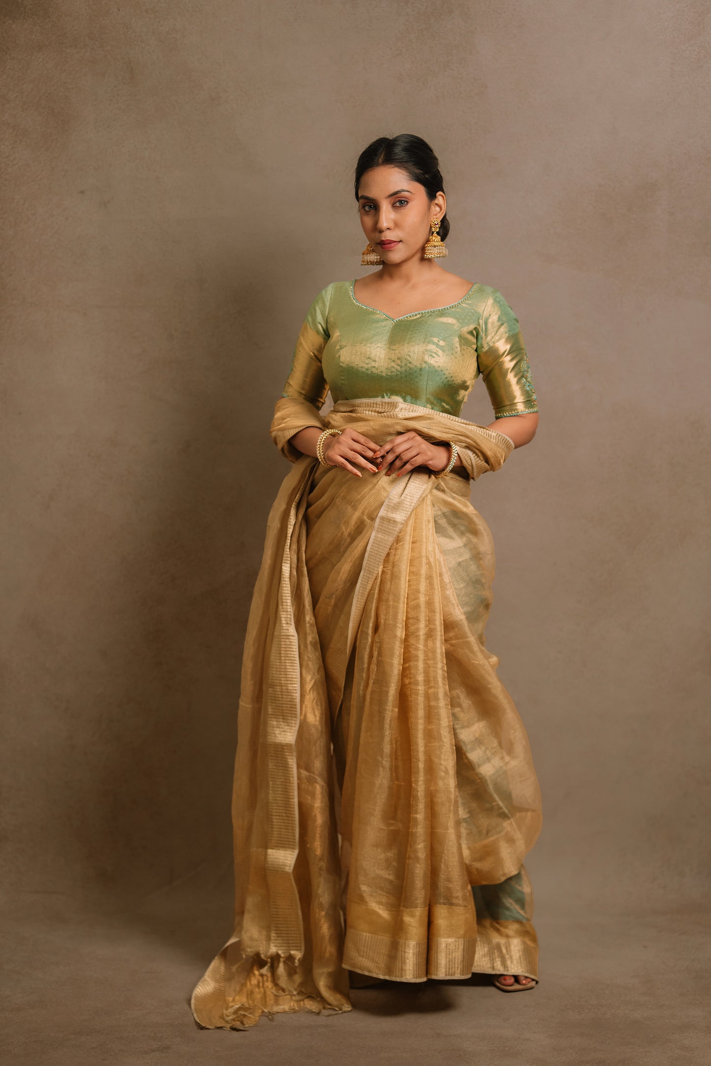 Model Dolly Aishwarya in a hand embroidered kanjivaram tissue silk blouse in pistachio green (dual tone silk).
Fashionable, high-quality craftsmanship that is stylish and affordable.