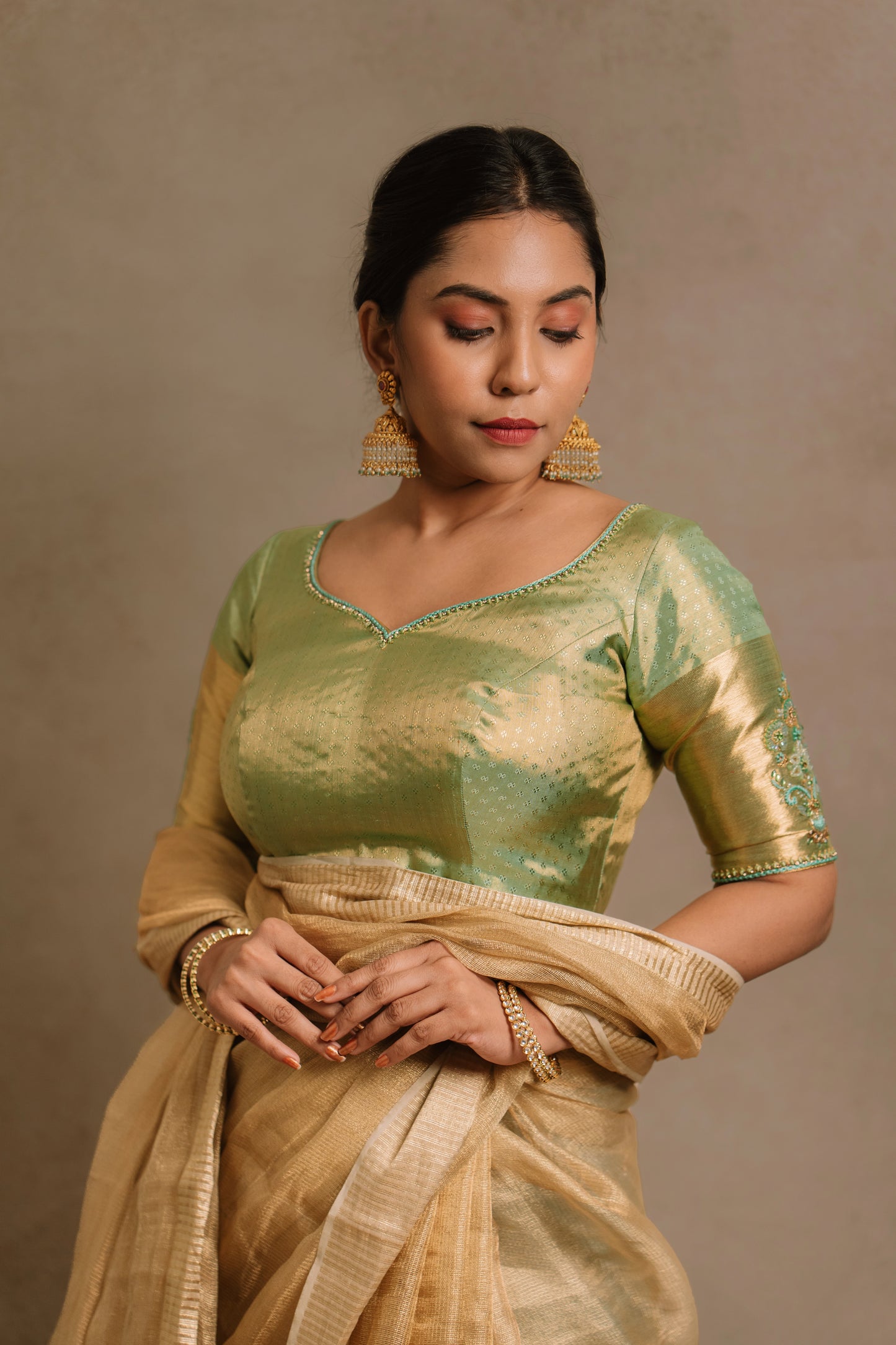 Model Dolly Aishwarya poses for photoshoot in a hand embroidered kanjivaram tissue silk blouse in pistachio green (dual tone silk).
Fashionable, high-quality craftsmanship that is stylish and affordable.