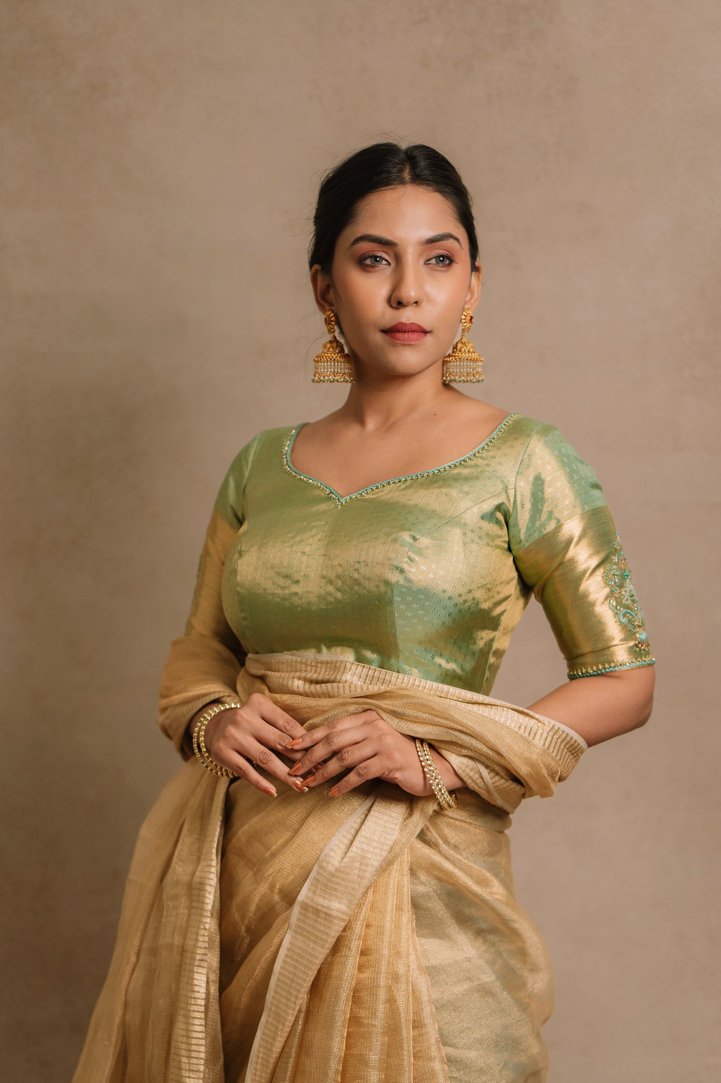 Model Dolly Aishwarya poses in a hand embroidered kanjivaram tissue silk blouse in pistachio green (dual tone silk).
Fashionable, high-quality craftsmanship that is stylish and affordable.