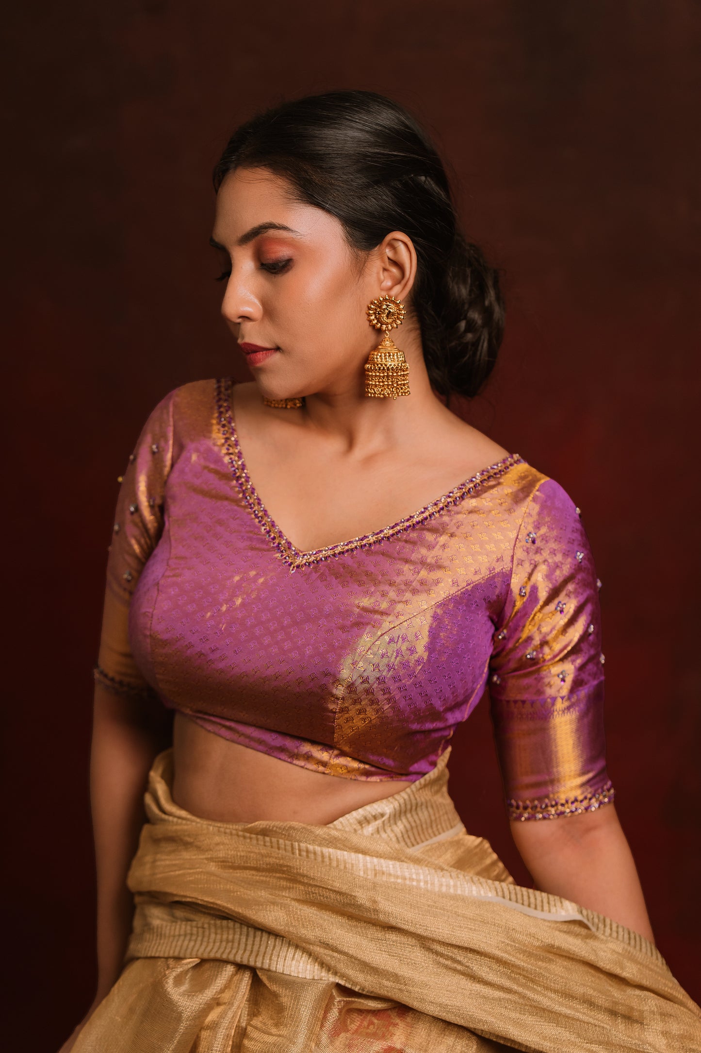 Model Dolly Aishwarya posing in a handcrafted kanjivaram tissue blouse in purple (Dual Tone Silk) by team AKloset. Fashionable, high-quality craftsmanship that is stylish and affordable.