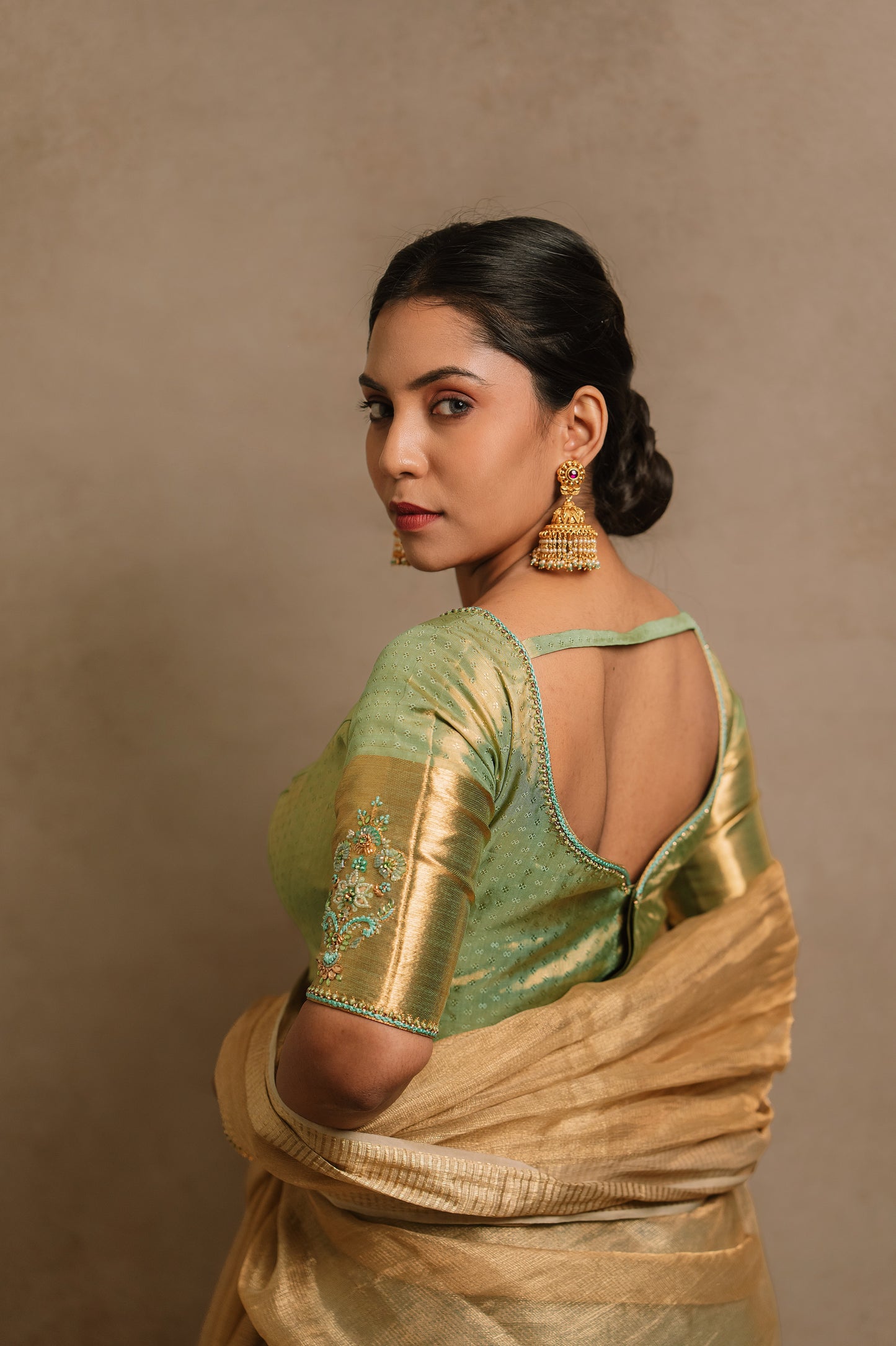 Model Dolly Aishwarya showcases blouse back design in a hand embroidered kanjivaram tissue silk blouse in pistachio green (dual tone silk).
Fashionable, high-quality craftsmanship that is stylish and affordable.