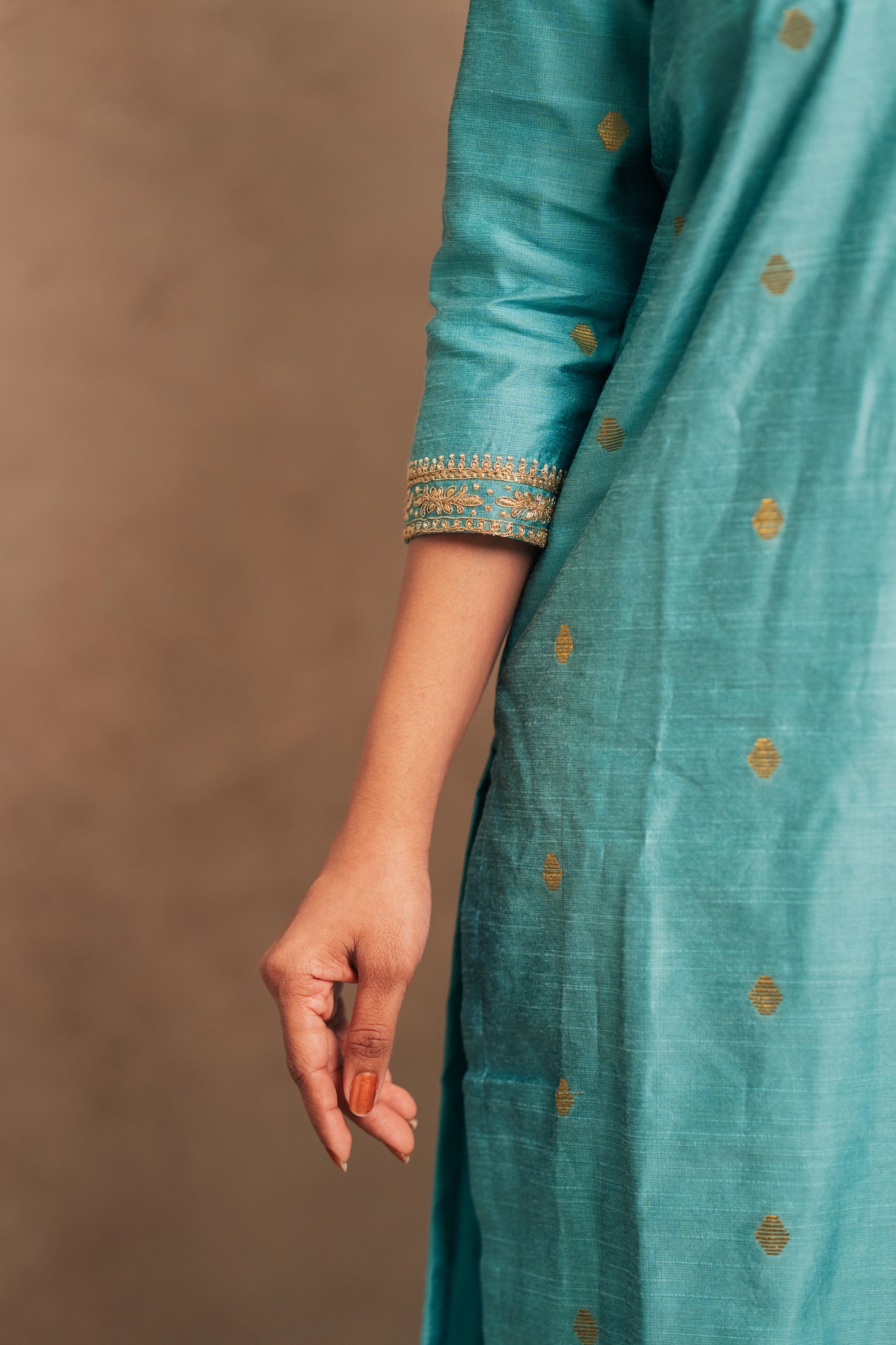 Model Dolly Aishwarya showcasing sleeve in an embroidered jute cotton kurti in tiffany blue by team AKloset.