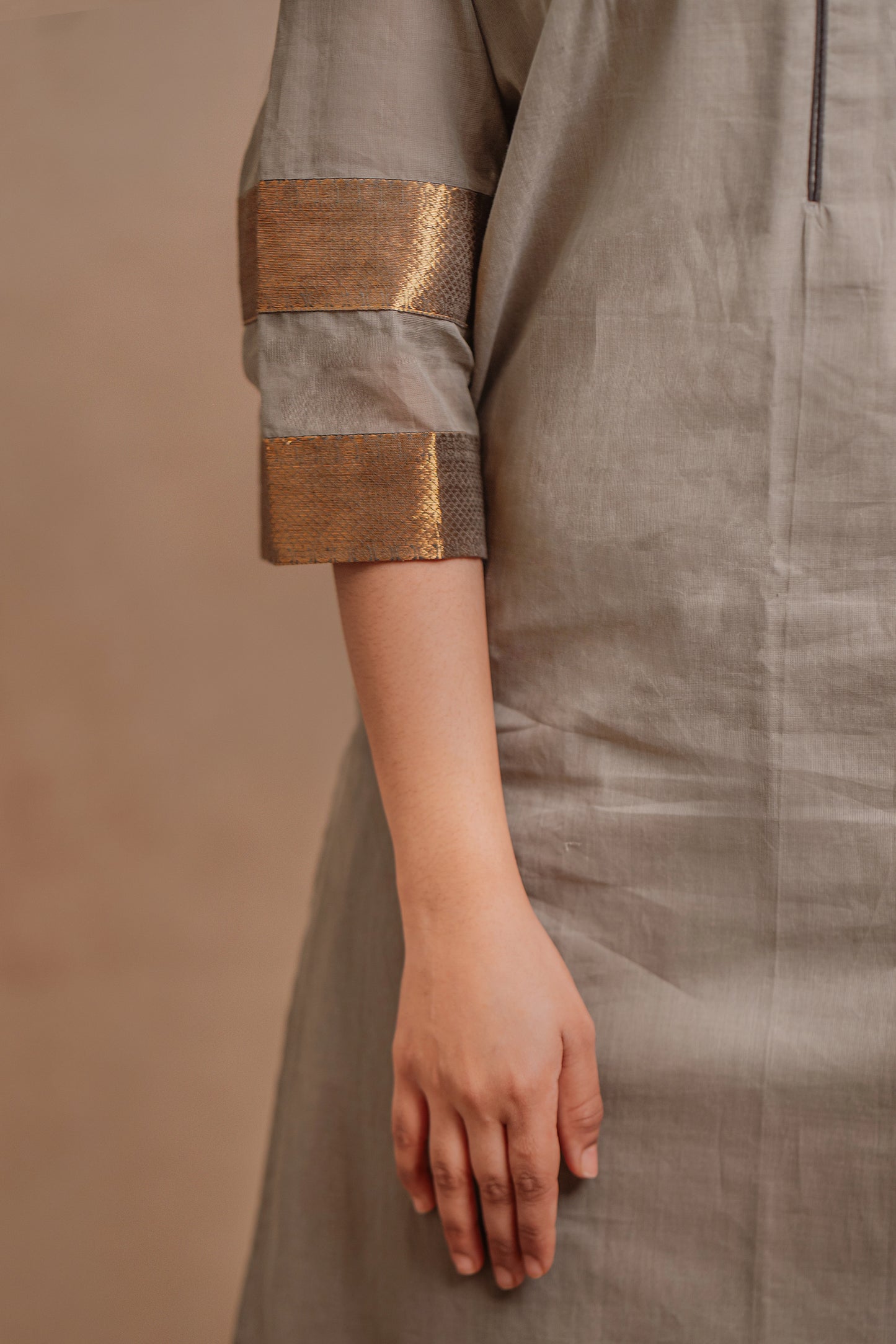 Model Jaina Parmar during photoshoot in an oversized kurti in gray with bell sleeves paired with a black pant by team AKloset.