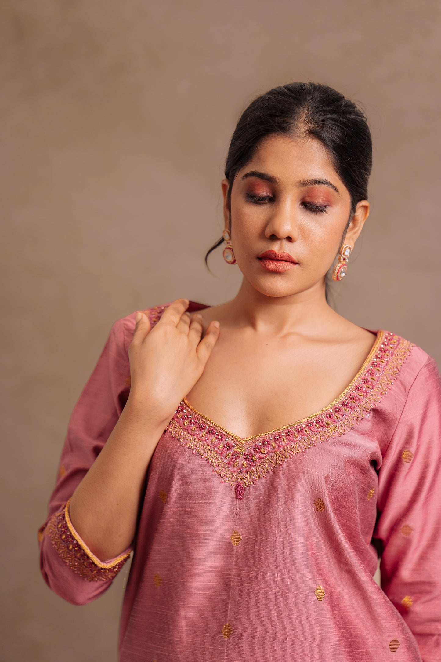 Model Jaina Parmar for a closeup shot in an embroidered jute cotton kurti set in onion pink by team AKloset.