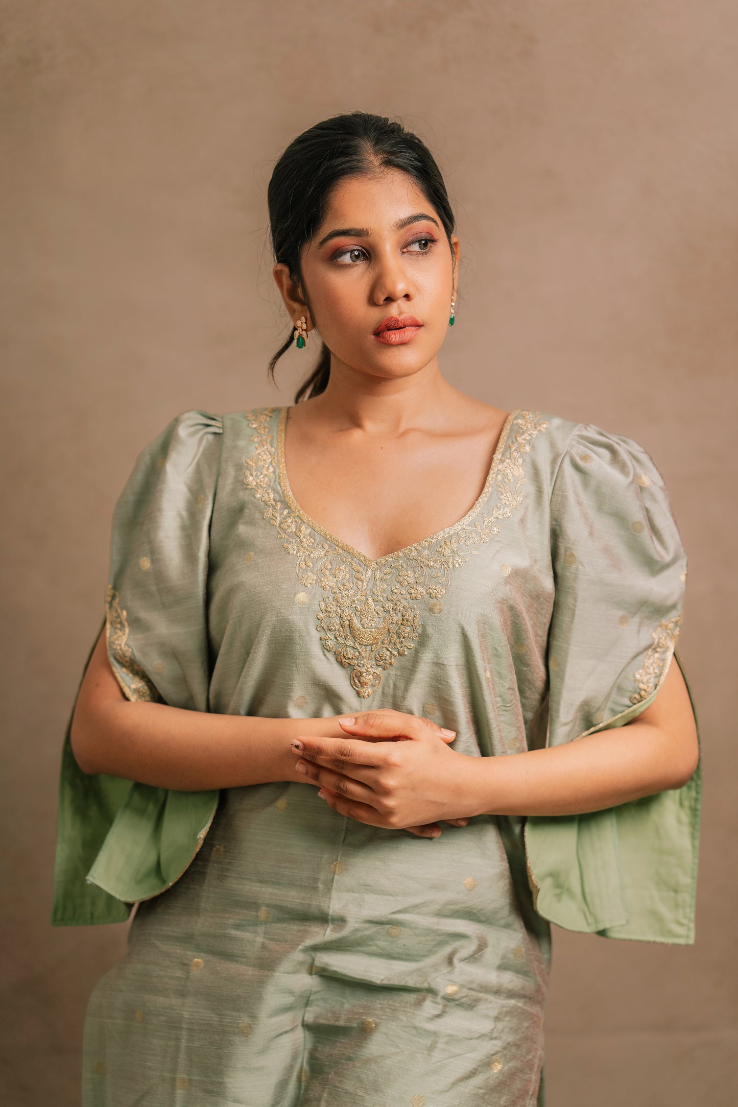 Model Jaina Parmar in a closeup shot in an embroidered jute cotton kurti set in muted pistachio green by team AKloset.