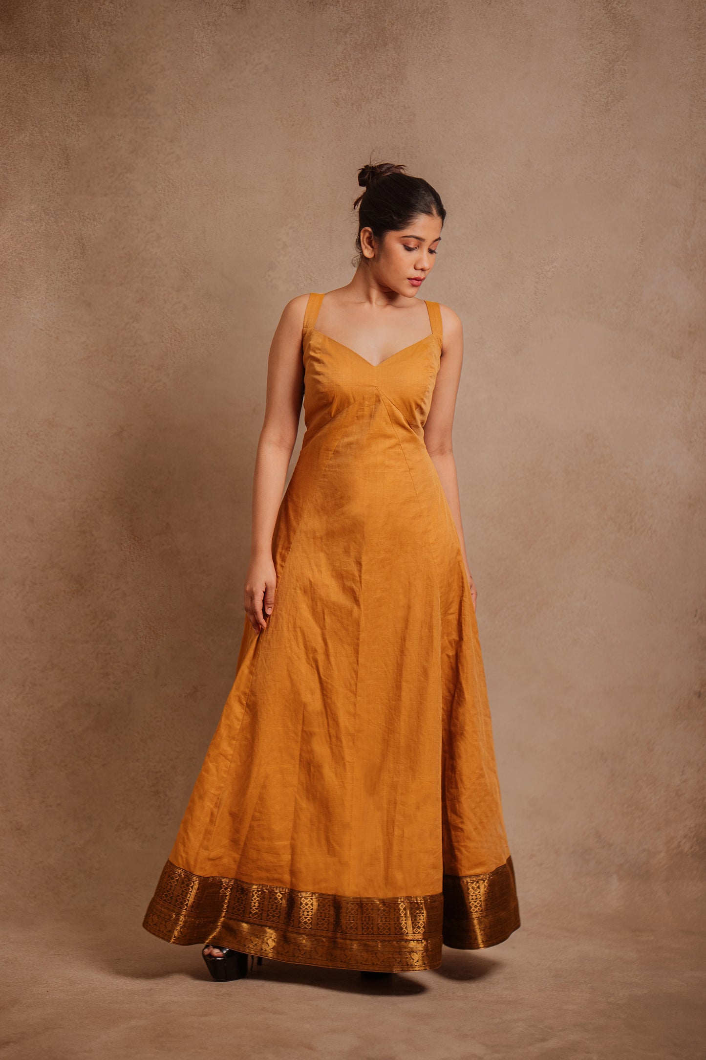 Model Jaina Parmar in a corset dress in mustard by team AKloset.