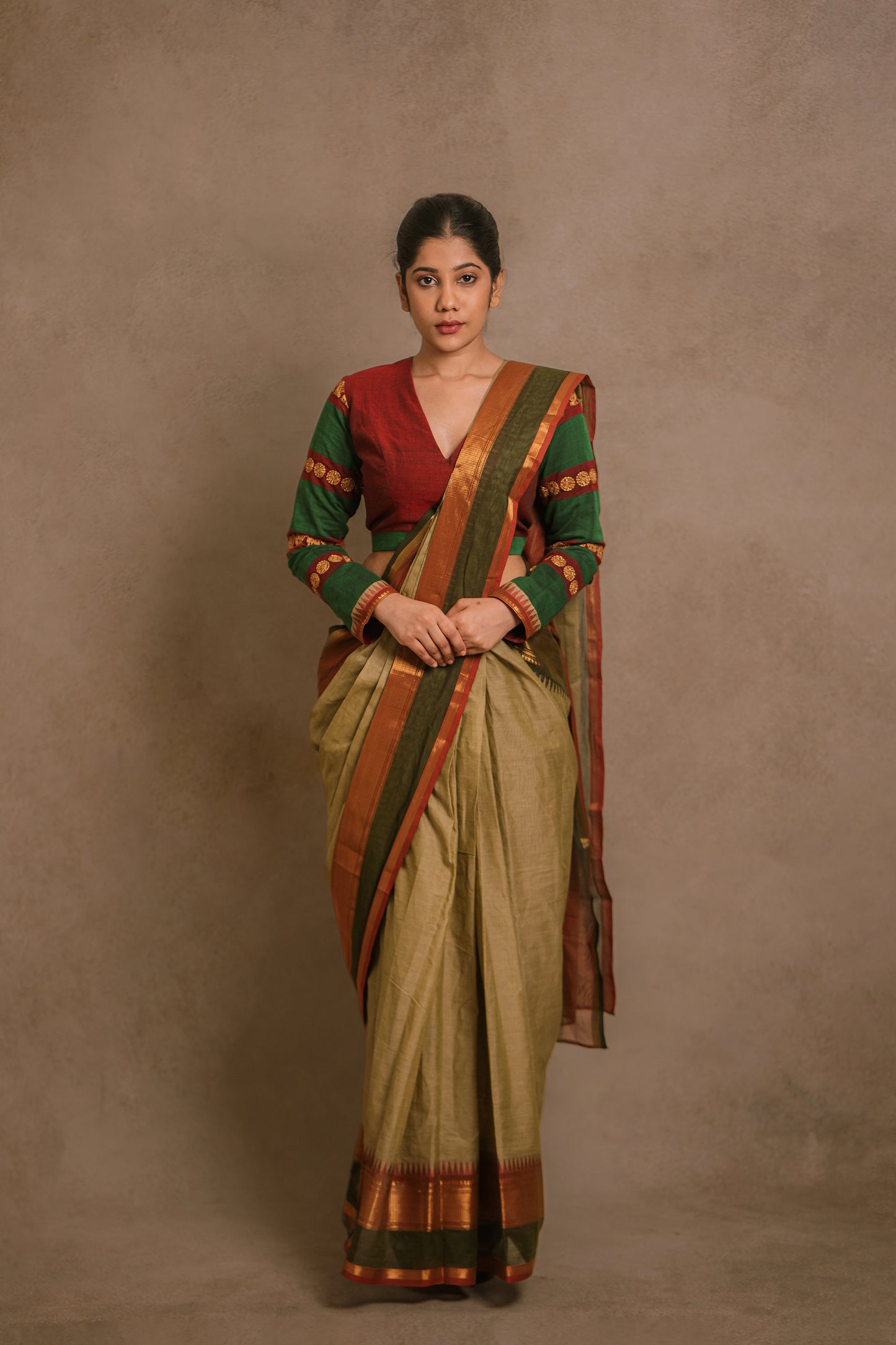 Model Jaina Parmar in a draped saree in sage green with a hand embroidered blouse in maroon & green by team AKloset.