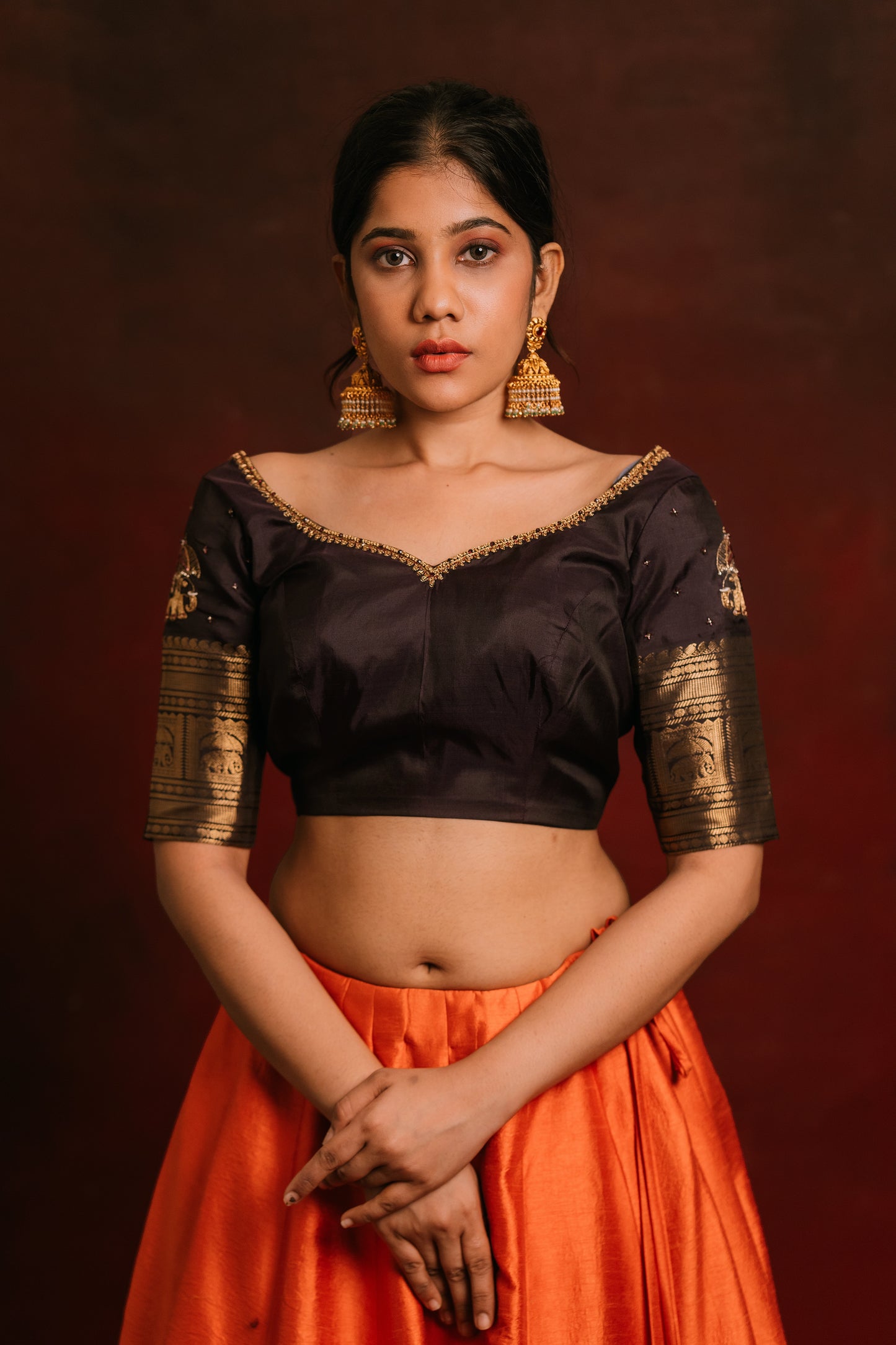 Model Jaina Parmar in a hand embroidered kanjivaram silk blouse in brown by team AKloset. Fashionable, high-quality craftsmanship that is stylish and affordable.