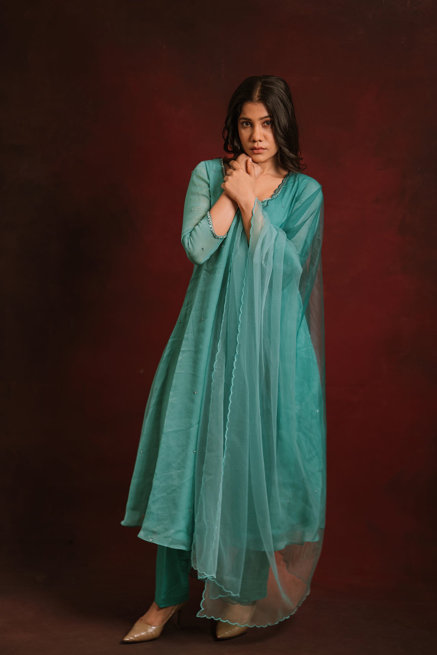 Model Jaina Parmar in a salwar set in shades of teal and turquoise tissue chiffon paired with a tulle ombre dupatta by team AKloset.