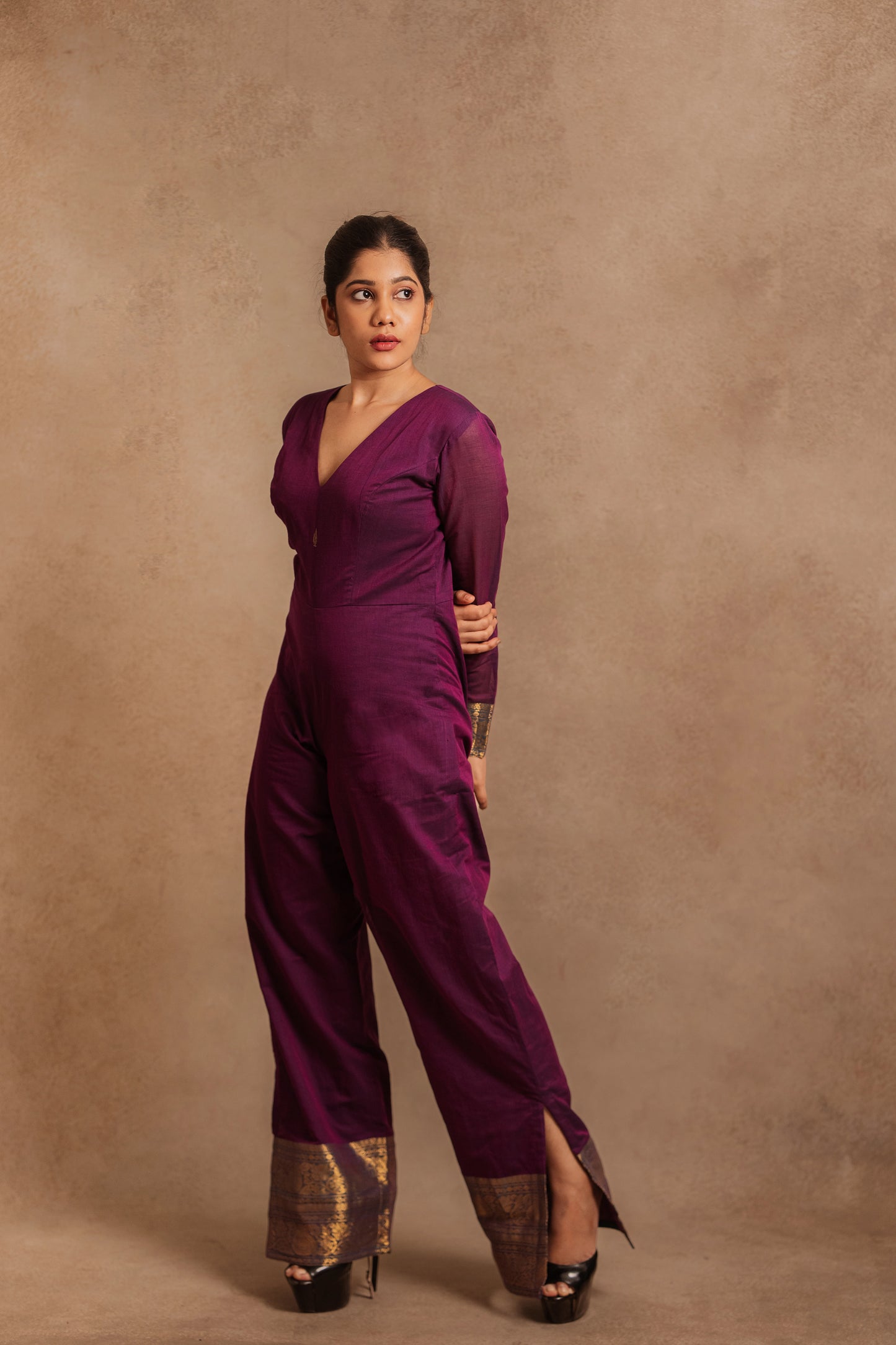 Model Jaina Parmar in a v-neck purple jumpsuit with a stylish low slit by team AKloset.