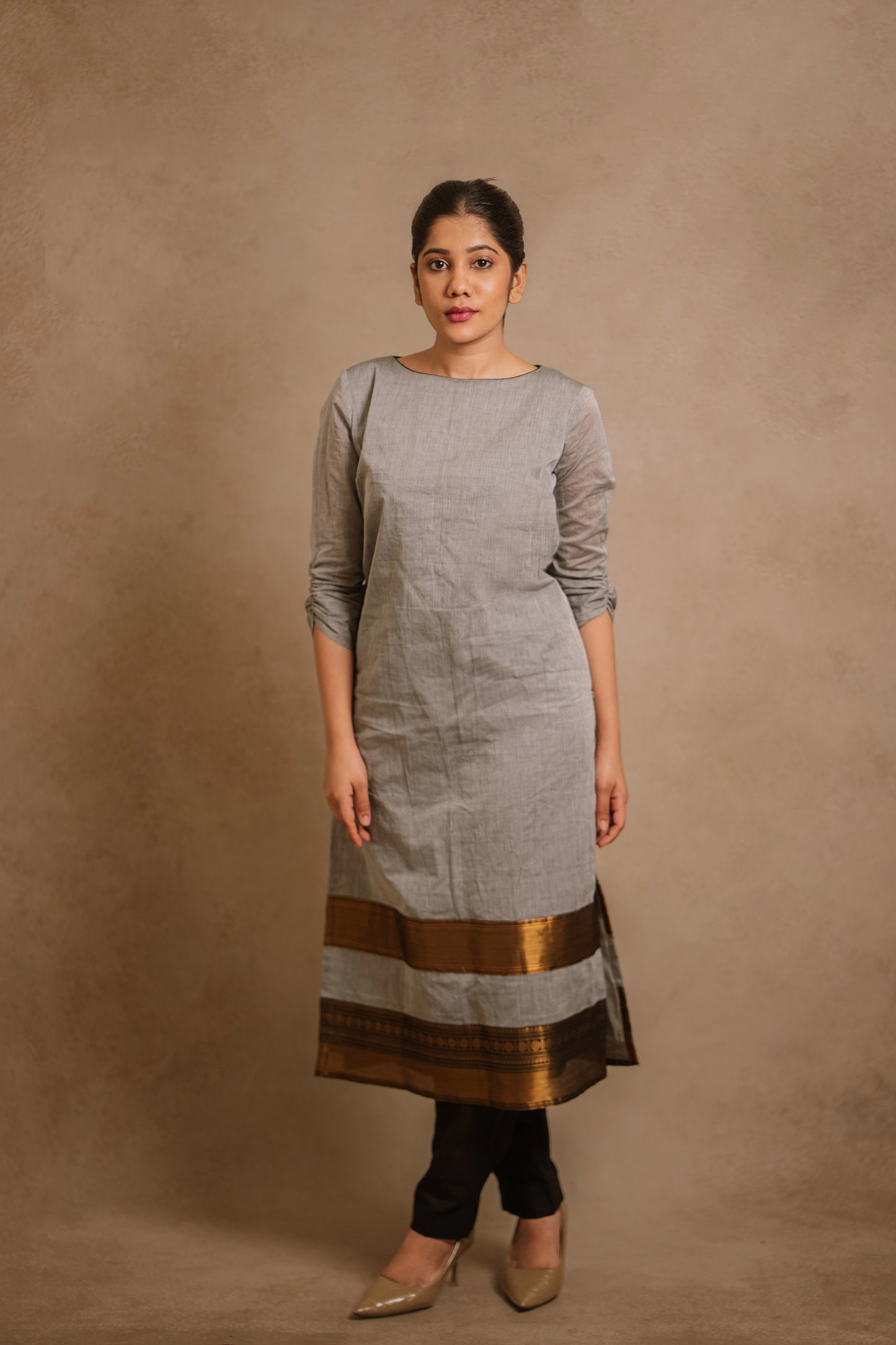 Model Jaina Parmar in an oversized gray kurti by team AKloset. A South Edit (Kanjivaram) piece is differentiated by the extravagant border native to Kanjivaram.