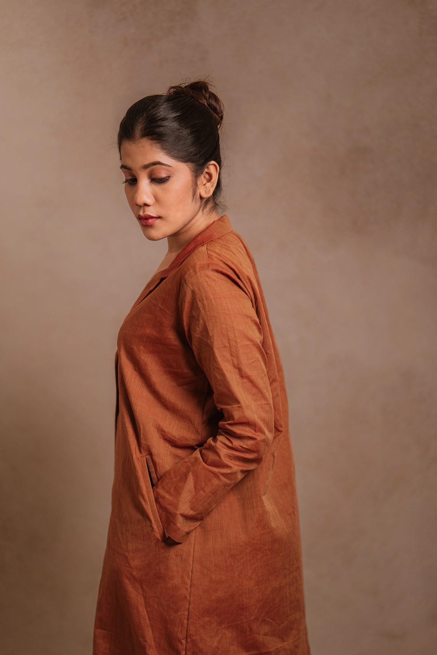 Model Jaina Parmar posing for side profile in a brown co-ord set by team AKloset.