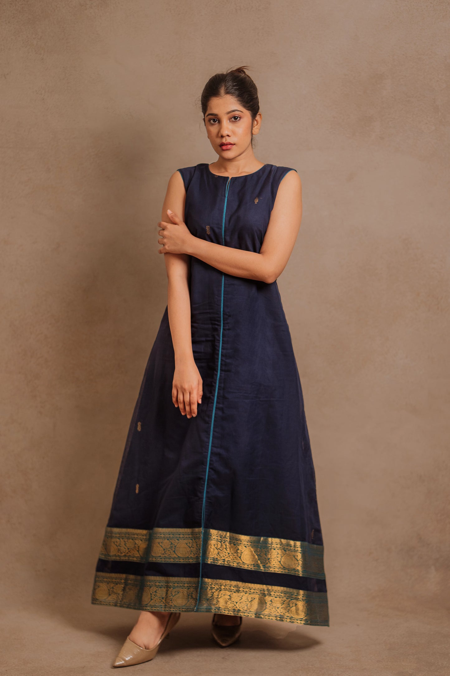 Model Jaina Parmar posing in a sleeveless a-line dress in blue by team AKloset.
