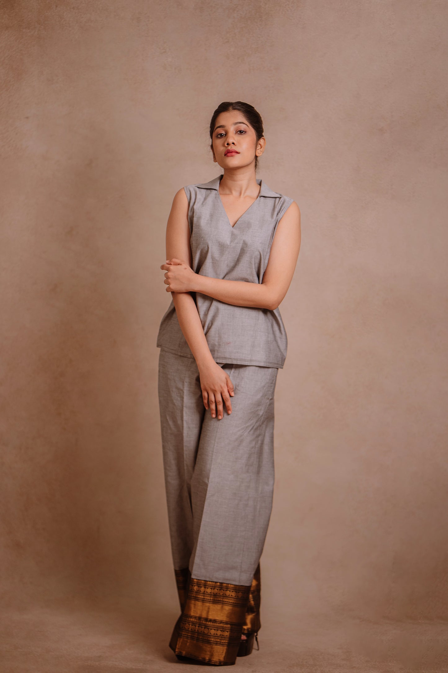 Model Jaina Parmar posing in a sleeveless co-ord set in gray by team AKloset.