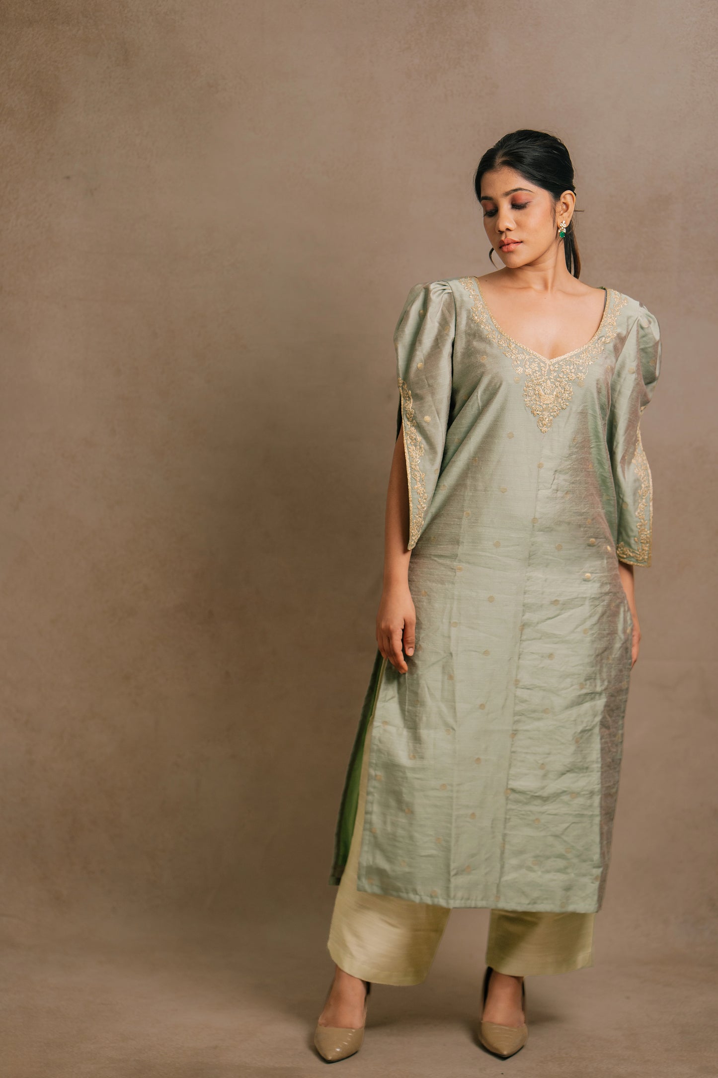 Model Jaina Parmar posing in an embroidered jute cotton kurti set in muted pistachio green by team AKloset.