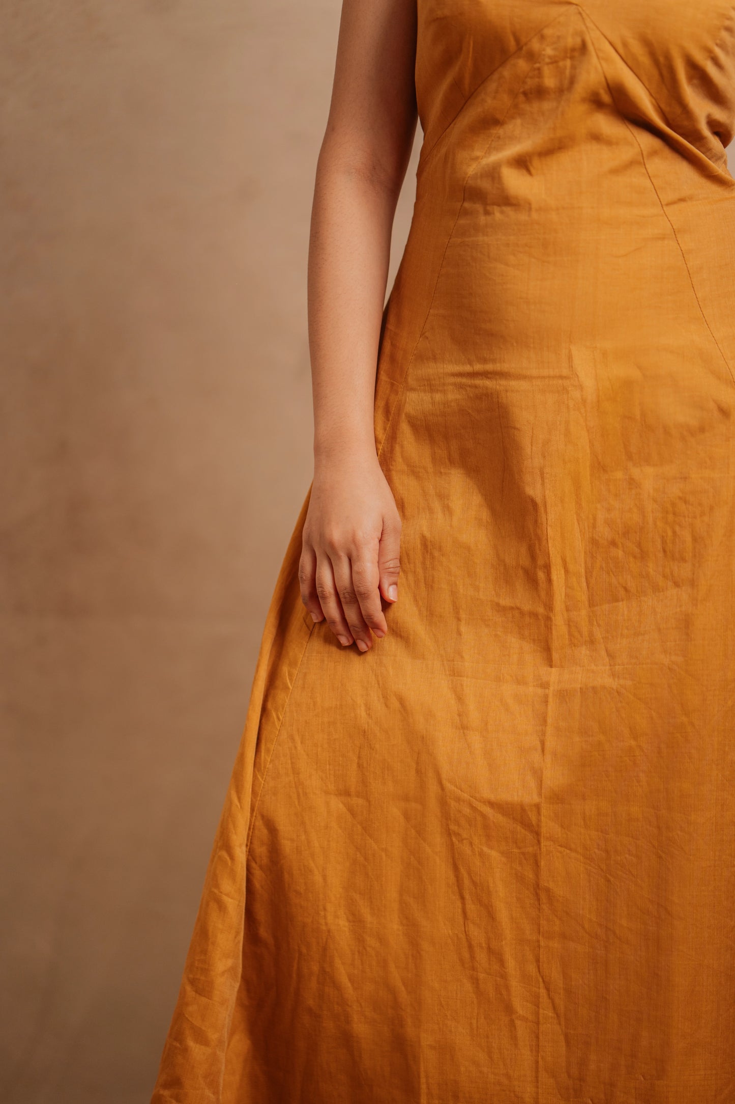 Model Jaina Parmar showcasing pattern of a corset dress in mustard by team AKloset.