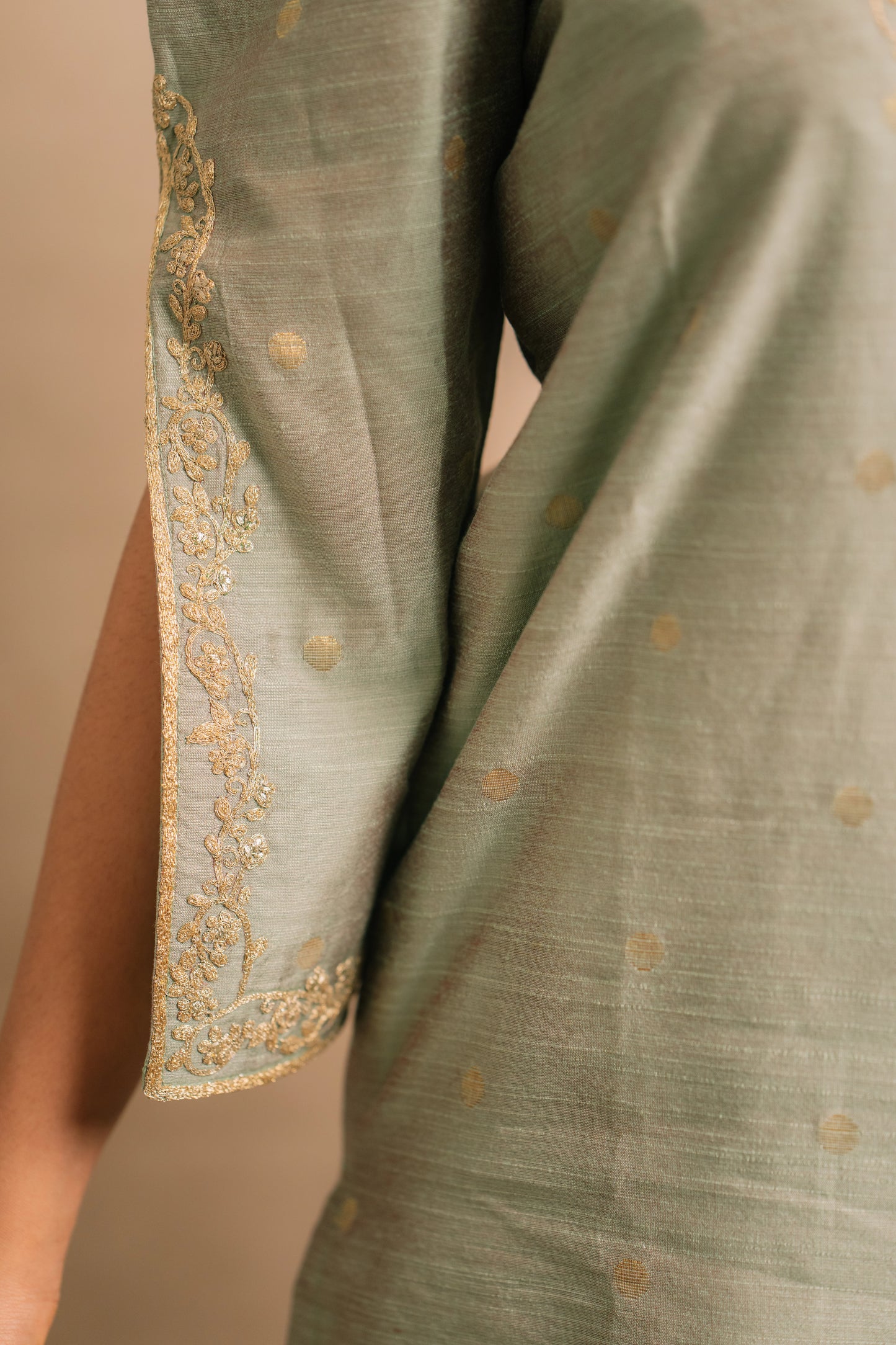 Model Jaina Parmar showcasing sleeve in an embroidered jute cotton kurti set in muted pistachio green by team AKloset.