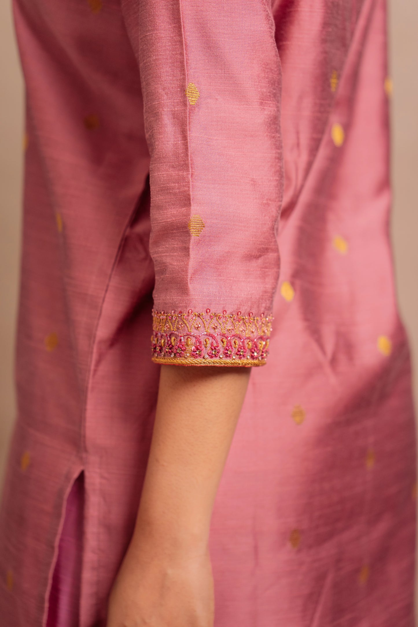 Model Jaina Parmar showcasing sleeve in an embroidered jute cotton kurti set in onion pink by team AKloset.