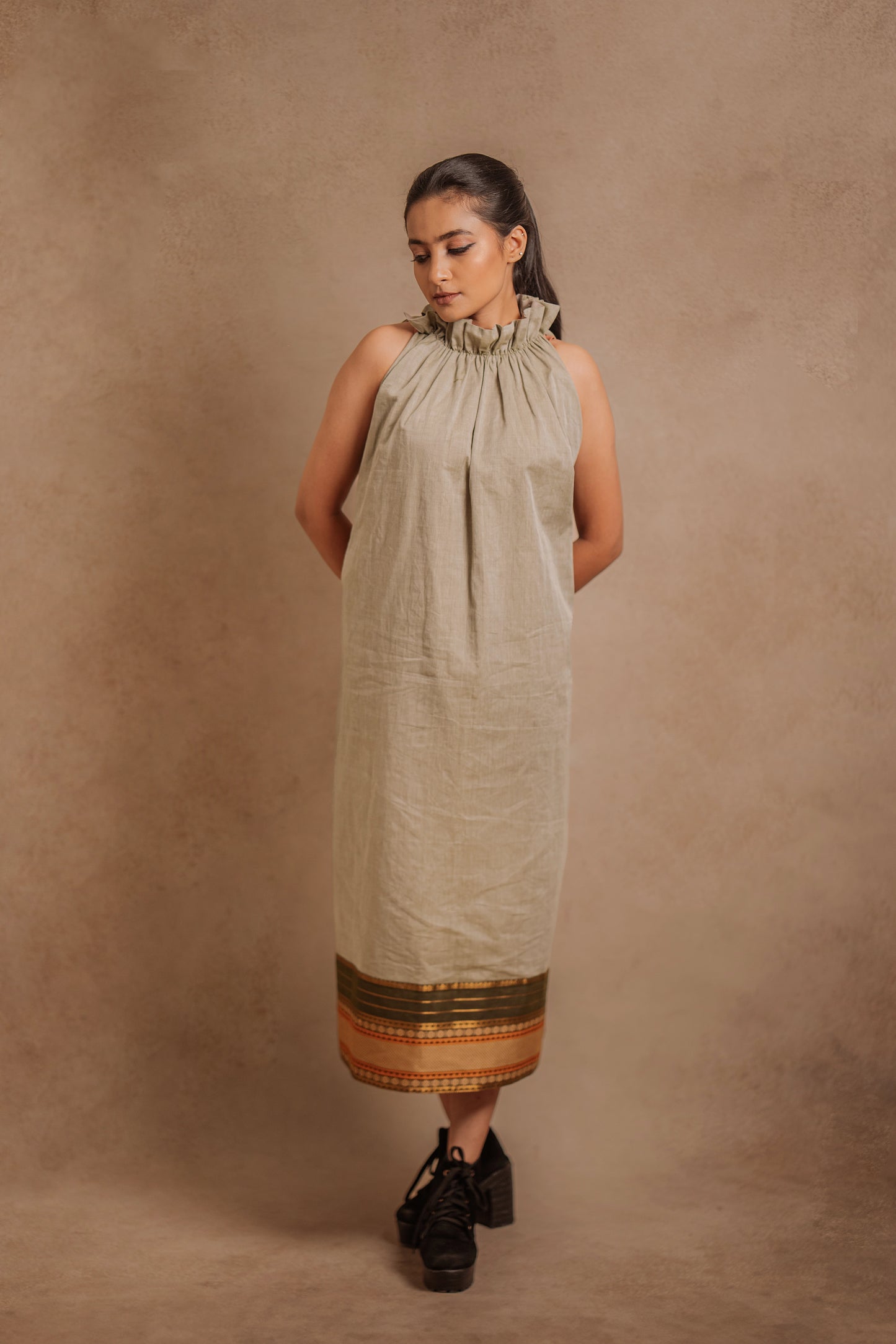 Model Krisha in a halterneck dress in sage green with a Halterneck by team Akloset.