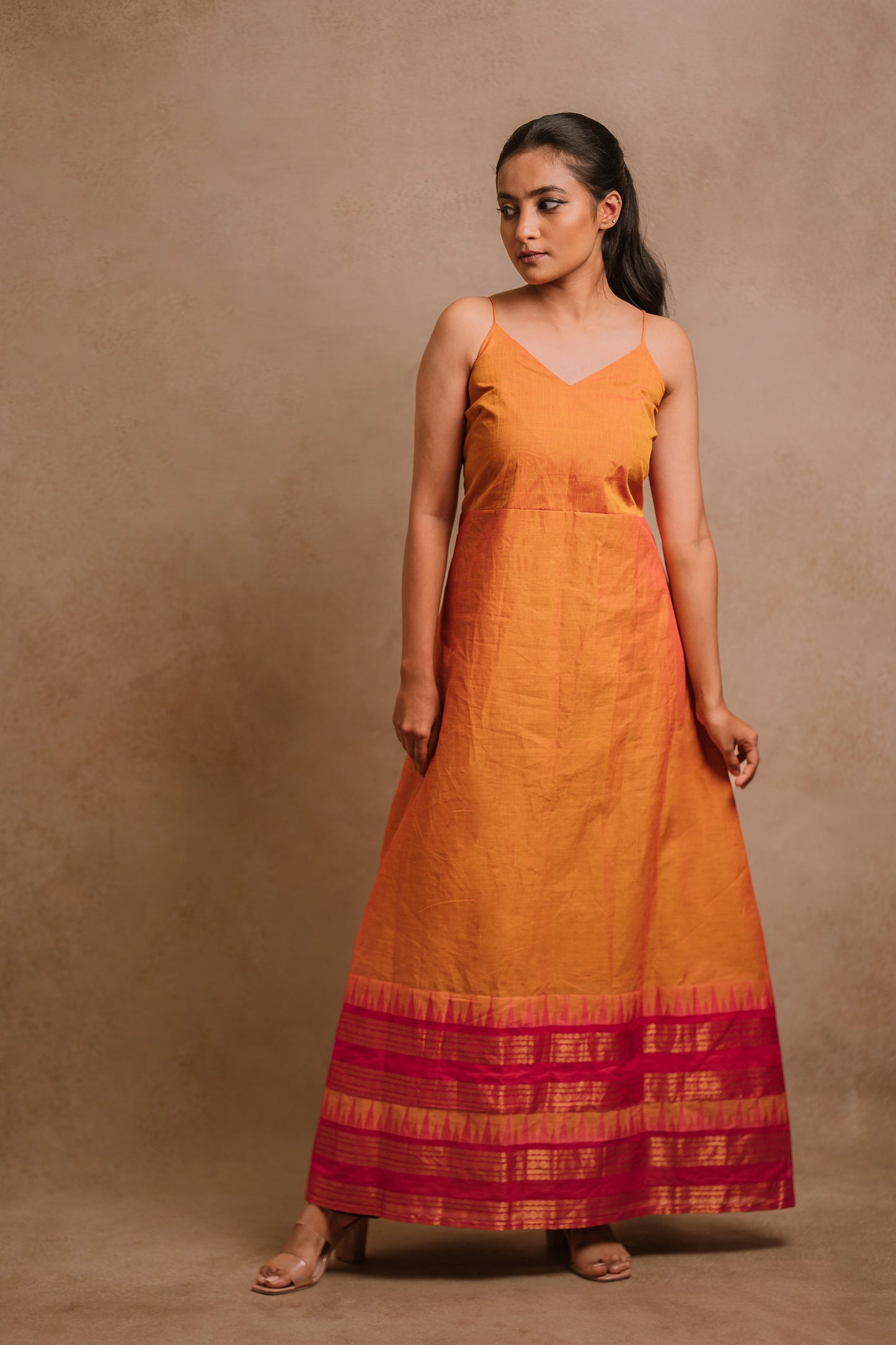 Model Krisha in an A-line sleeveless dress in orange (dual tone fabric) by team AKloset.