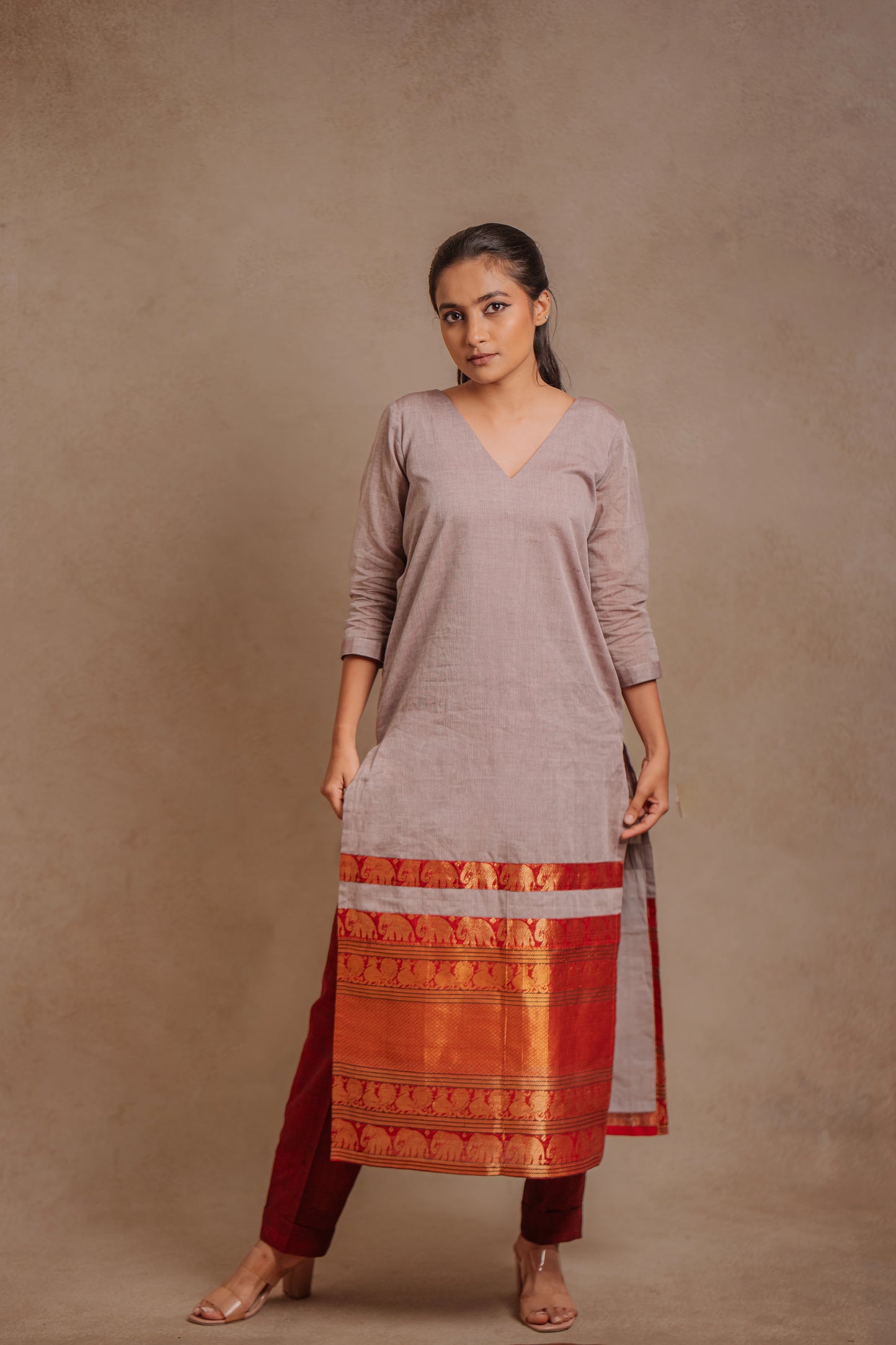 Model Krisha in an oversized south cotton kurti in gray paired with a maroon pant by team AKloset.