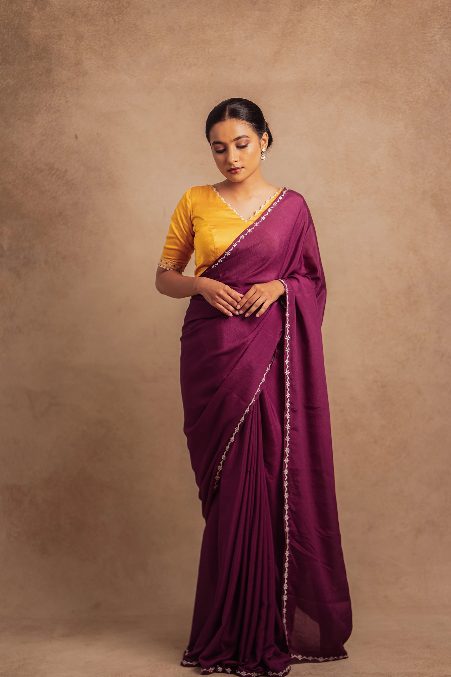 Model Krisha in embroidered shimmer chiffon saree in purple paired with an embroidered mustard yellow chanderi blouse by AKloset.