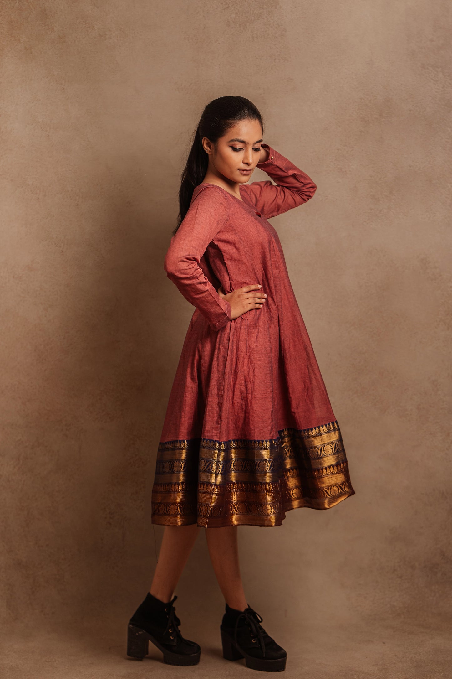 Model Krisha posing in a kalidar dress in onion pink by team AKloset.