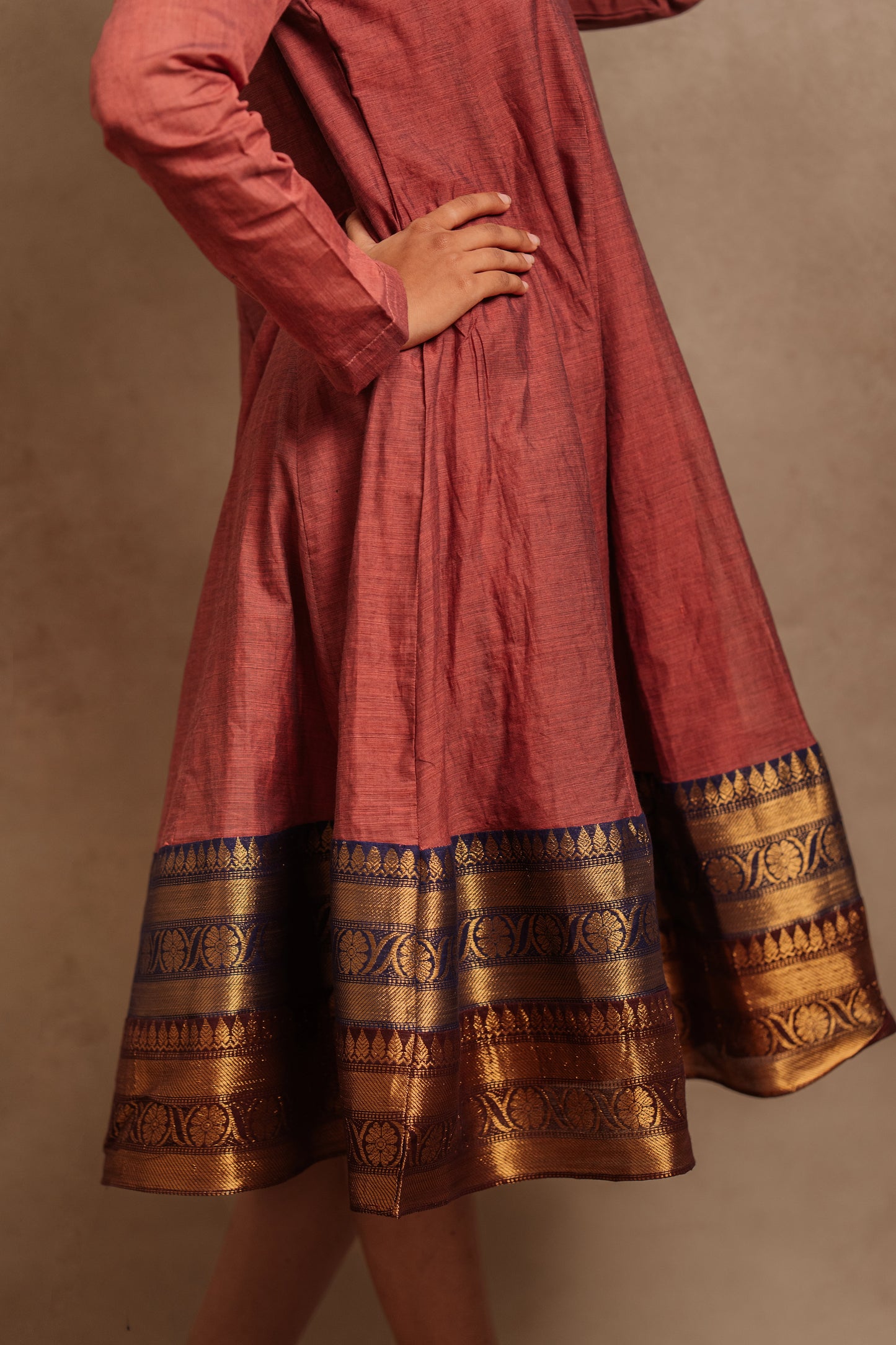 Model Krisha showcasing the border of a kalidar dress in onion pink by team AKloset.