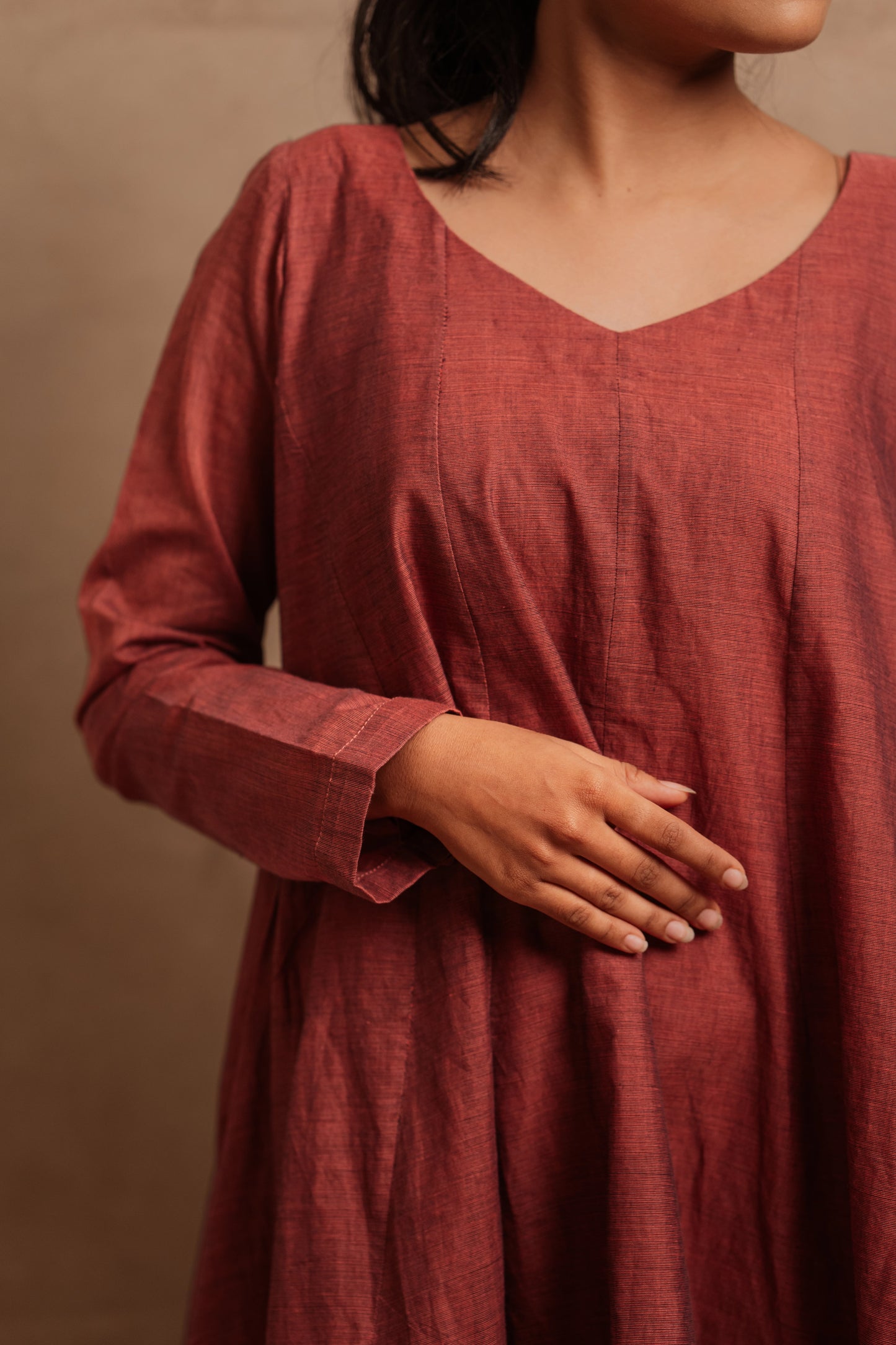 Model Krisha showcasing the fabric of a kalidar dress in onion pink by team AKloset.