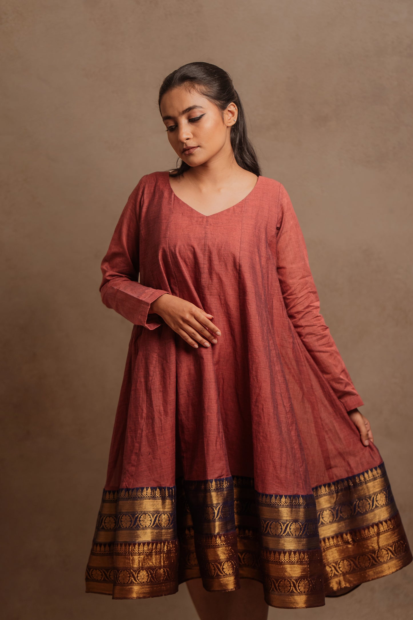 Model Krisha showcasing the flare of a kalidar dress in onion pink by team AKloset.