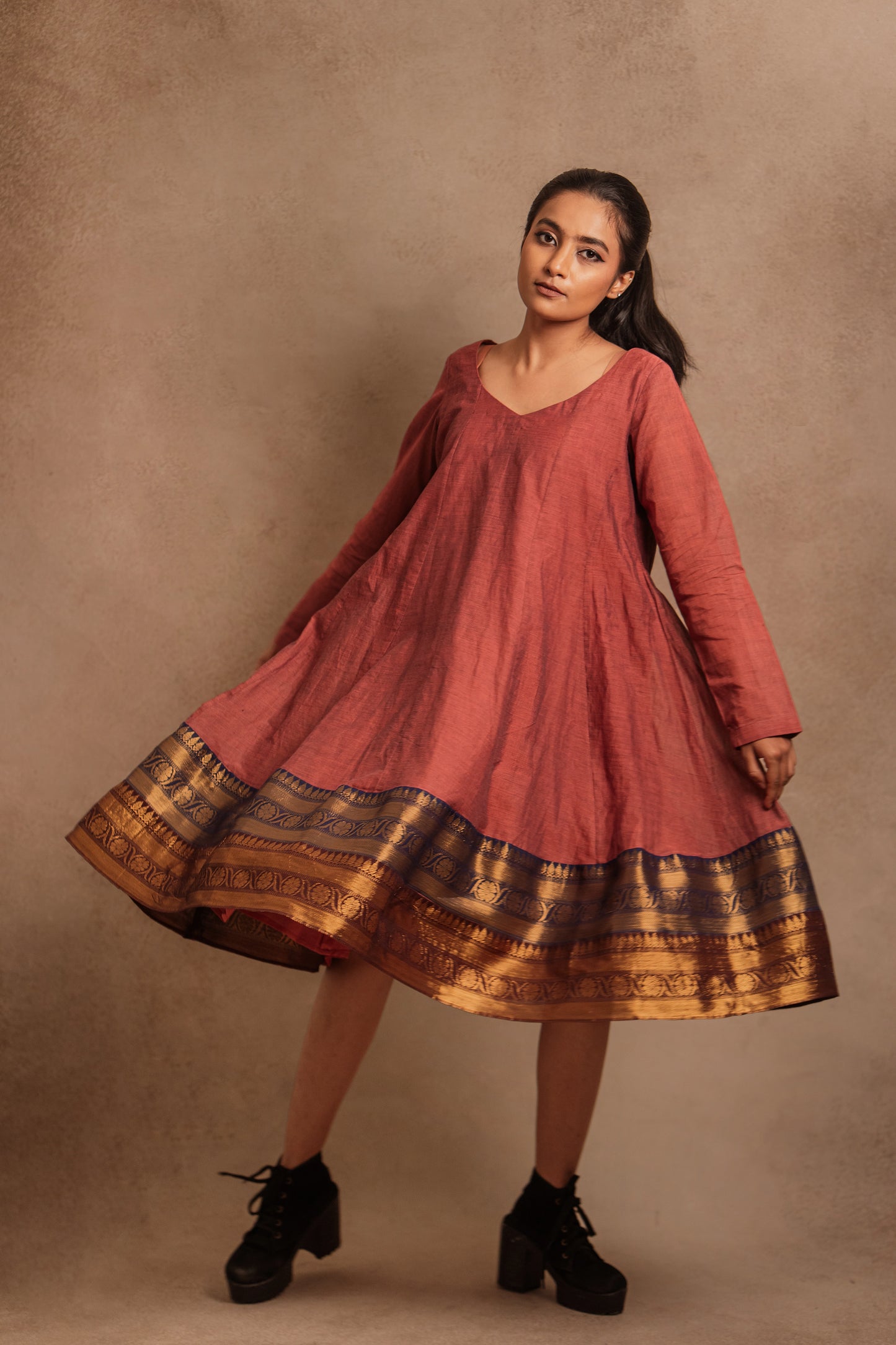 Model Krisha twirling in a kalidar dress in onion pink by team AKloset.