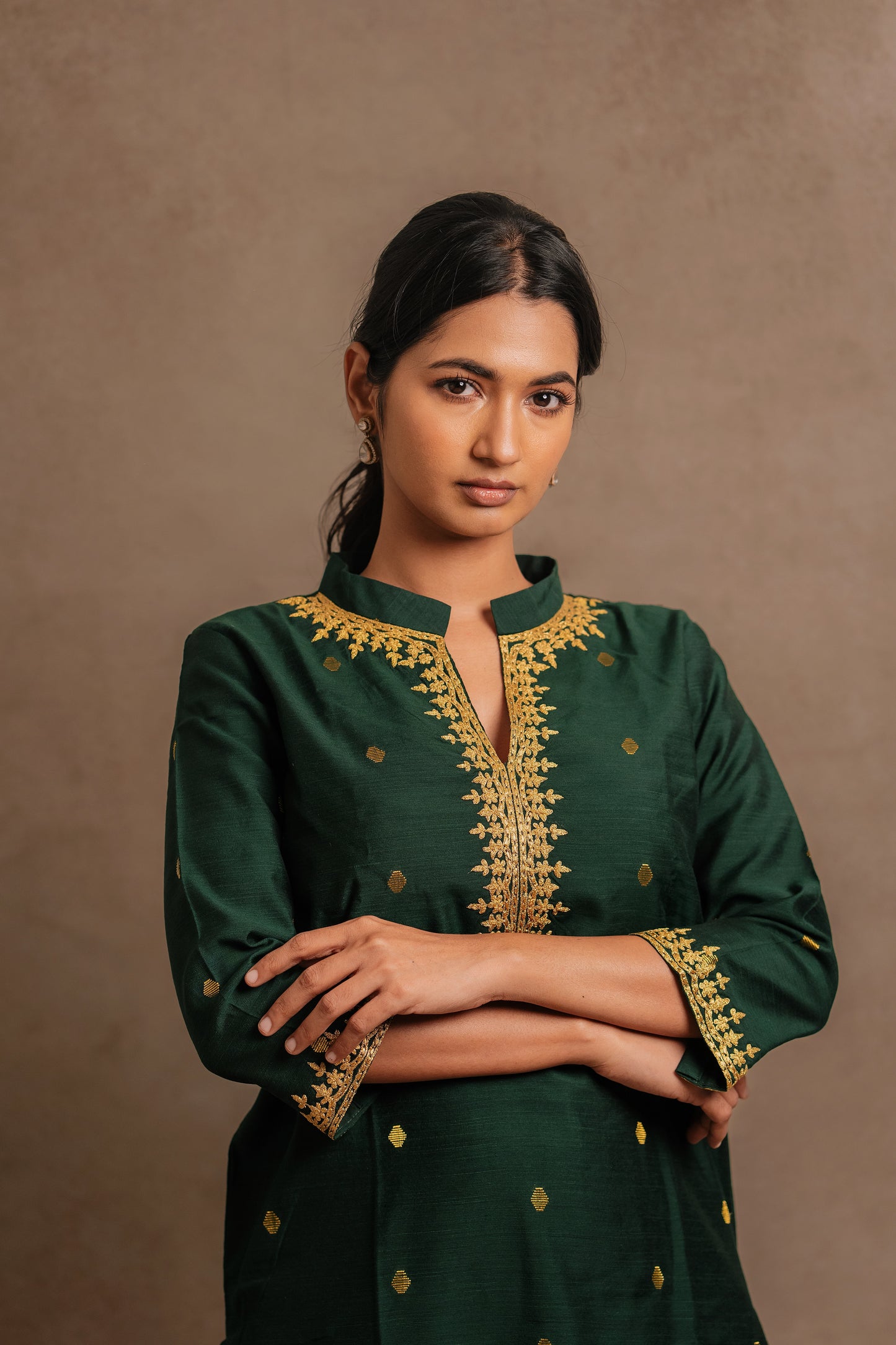 Model Premika Sekar in a closeup shot in an embroidered jute cotton kurti in bottle green by team AKloset.