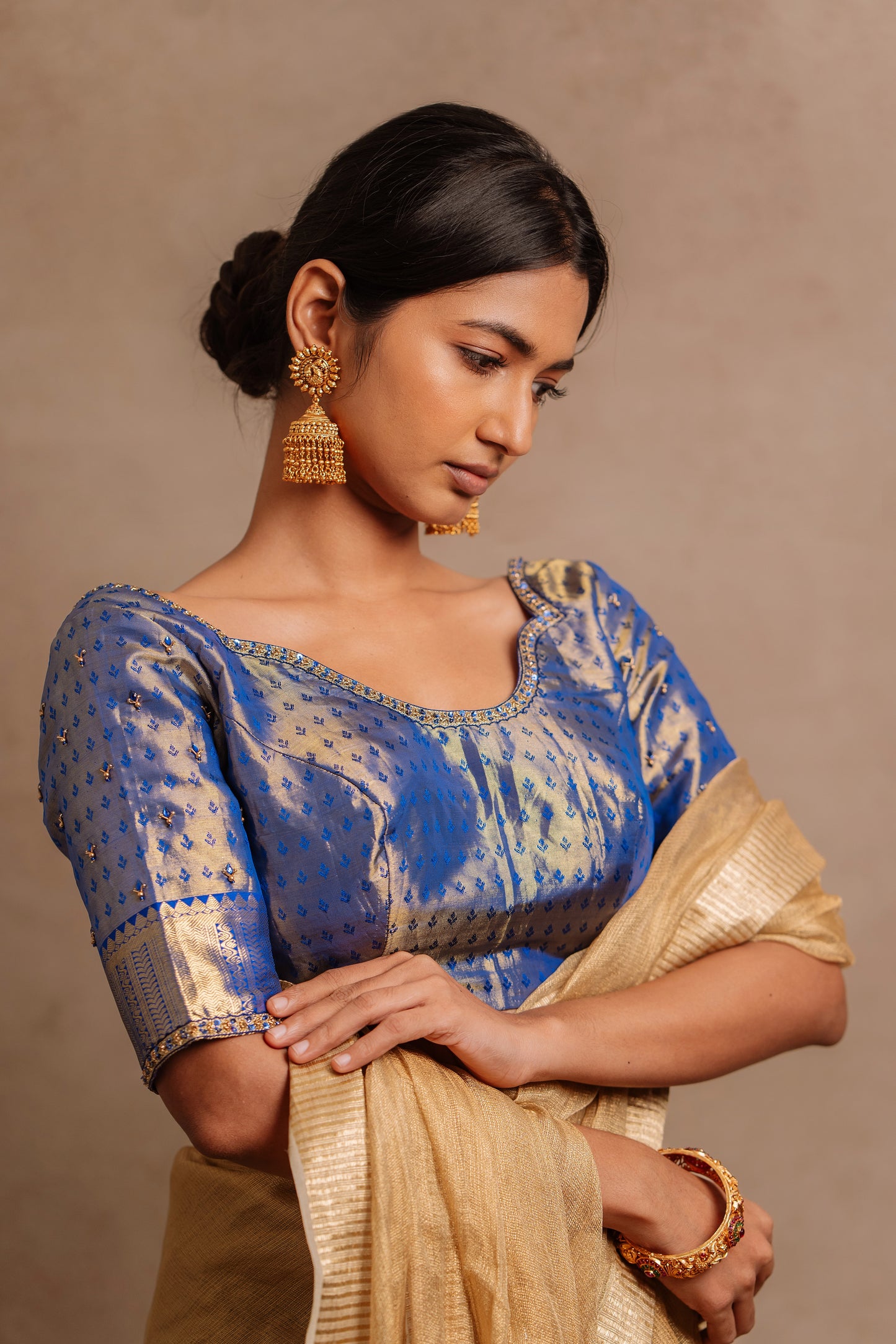 Model Premika Sekar in a hand embroidered Kanjivaram tissue silk blouse in blue (Dual Tone Silk) by team AKloset.