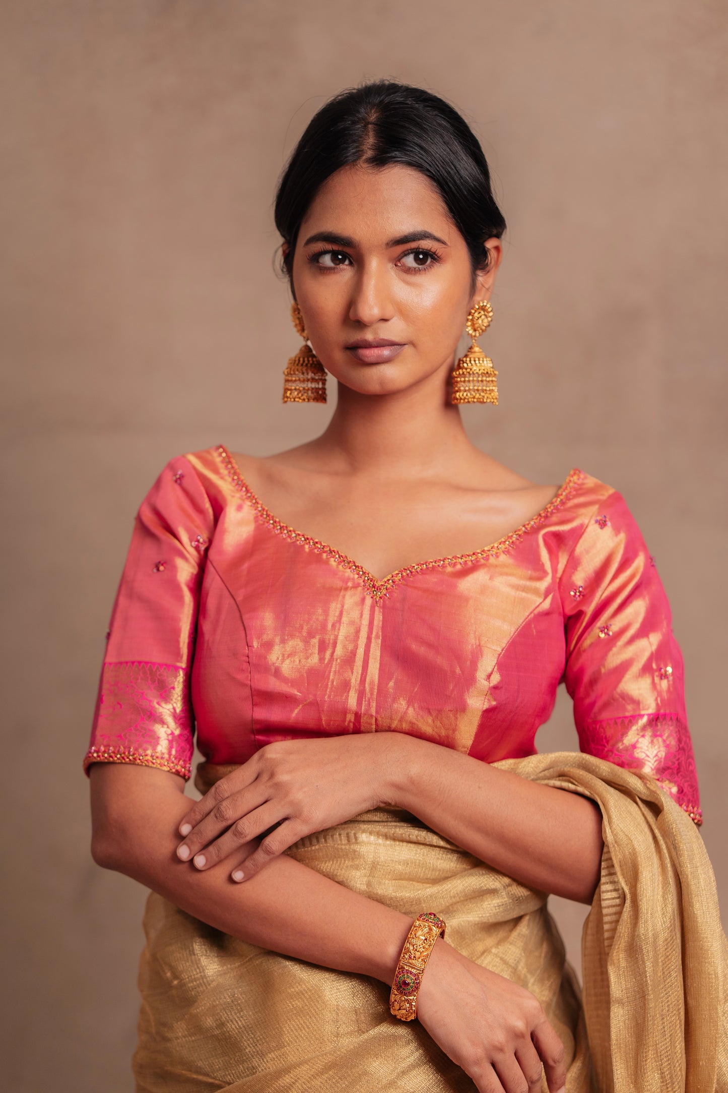 Model Premika Sekar posing for photoshoot in a hand embroidered Kanjivaram tissue silk blouse in pink (Dual Tone Silk) by team AKloset.