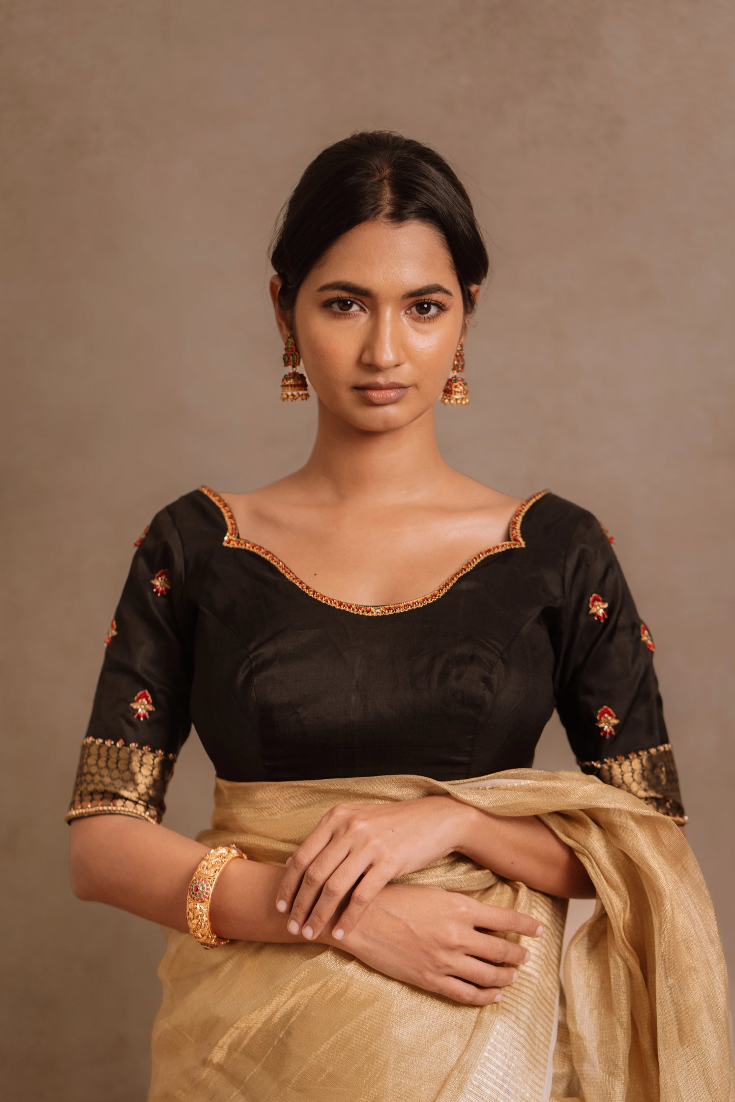 Model Premika Sekar in a hand embroidered kanjivaram silk blouse in black by team AKloset.