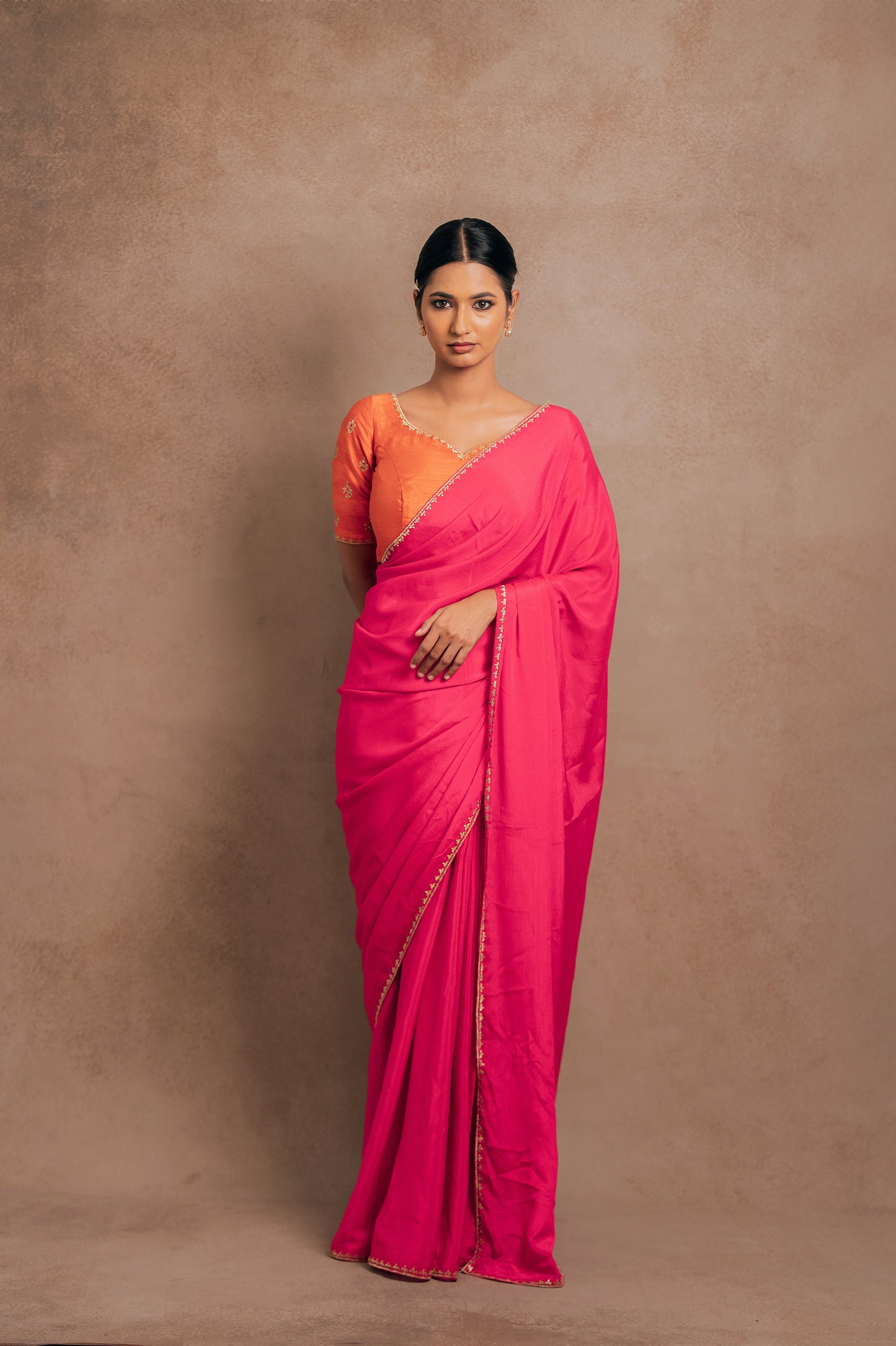 Model Premika Sekar in a pink shimmer chiffon saree paired with an embroidered orange raw silk blouse designed by team AKloset.