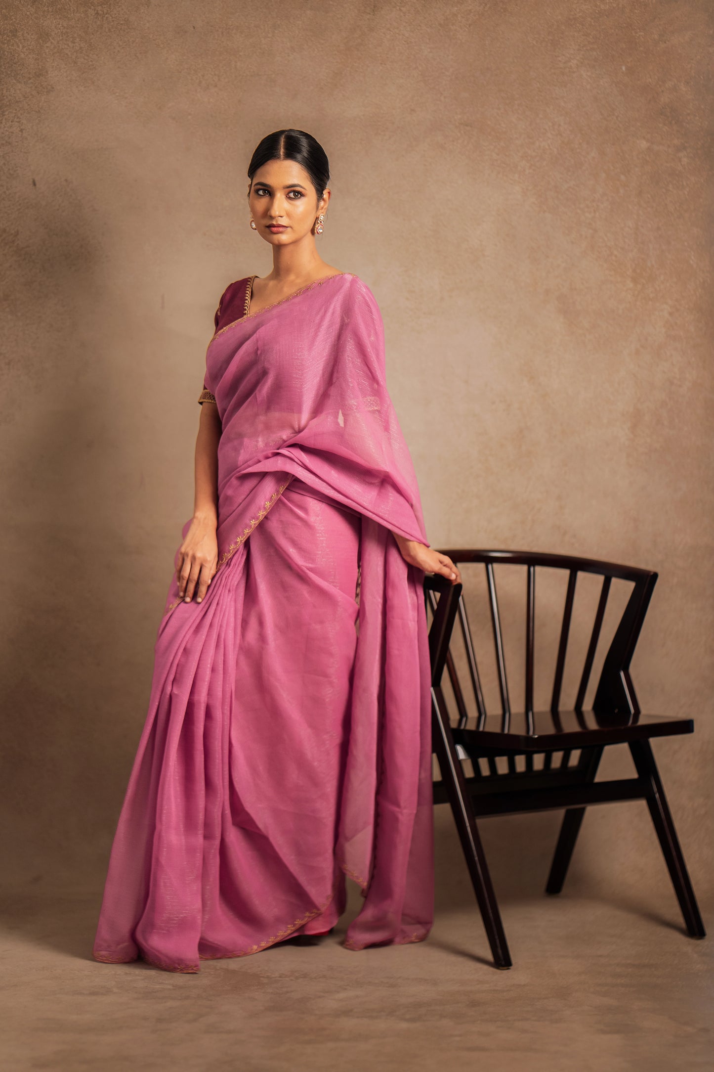 Model Premika Sekar in an embroidered Tissue Chiffon Saree in Onion Pink with an Embroidered Chanderi Blouse in Plum.