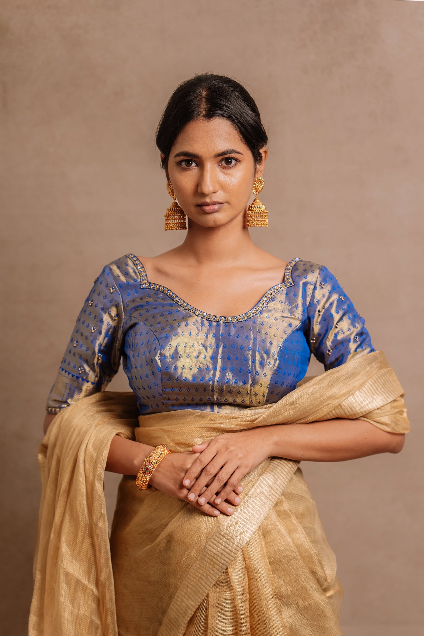Model Premika Sekar posing for photoshoot in a hand embroidered Kanjivaram tissue silk blouse in blue (Dual Tone Silk) by team AKloset.