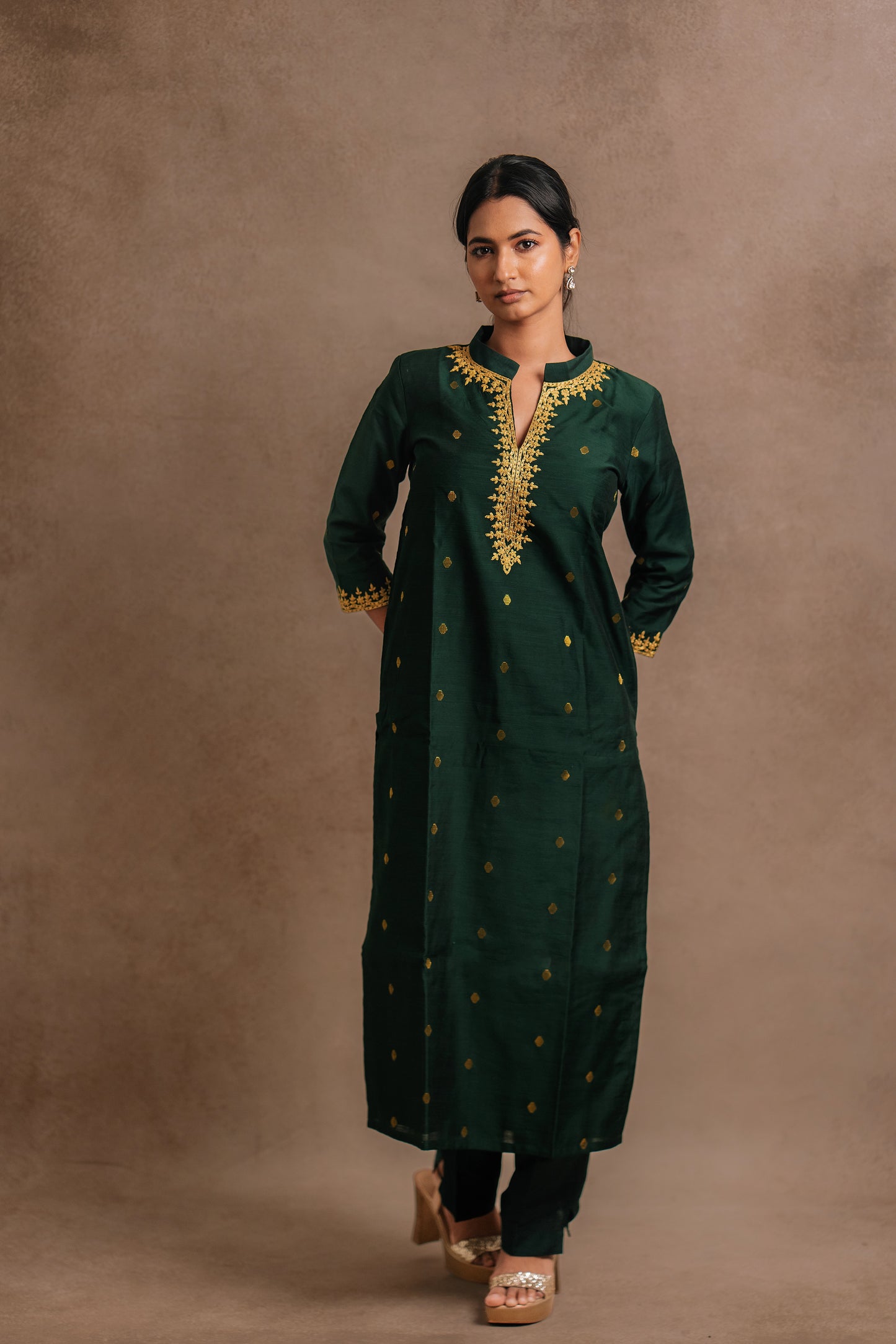 Model Premika Sekar posing in an embroidered jute cotton kurti in bottle green by team AKloset.
