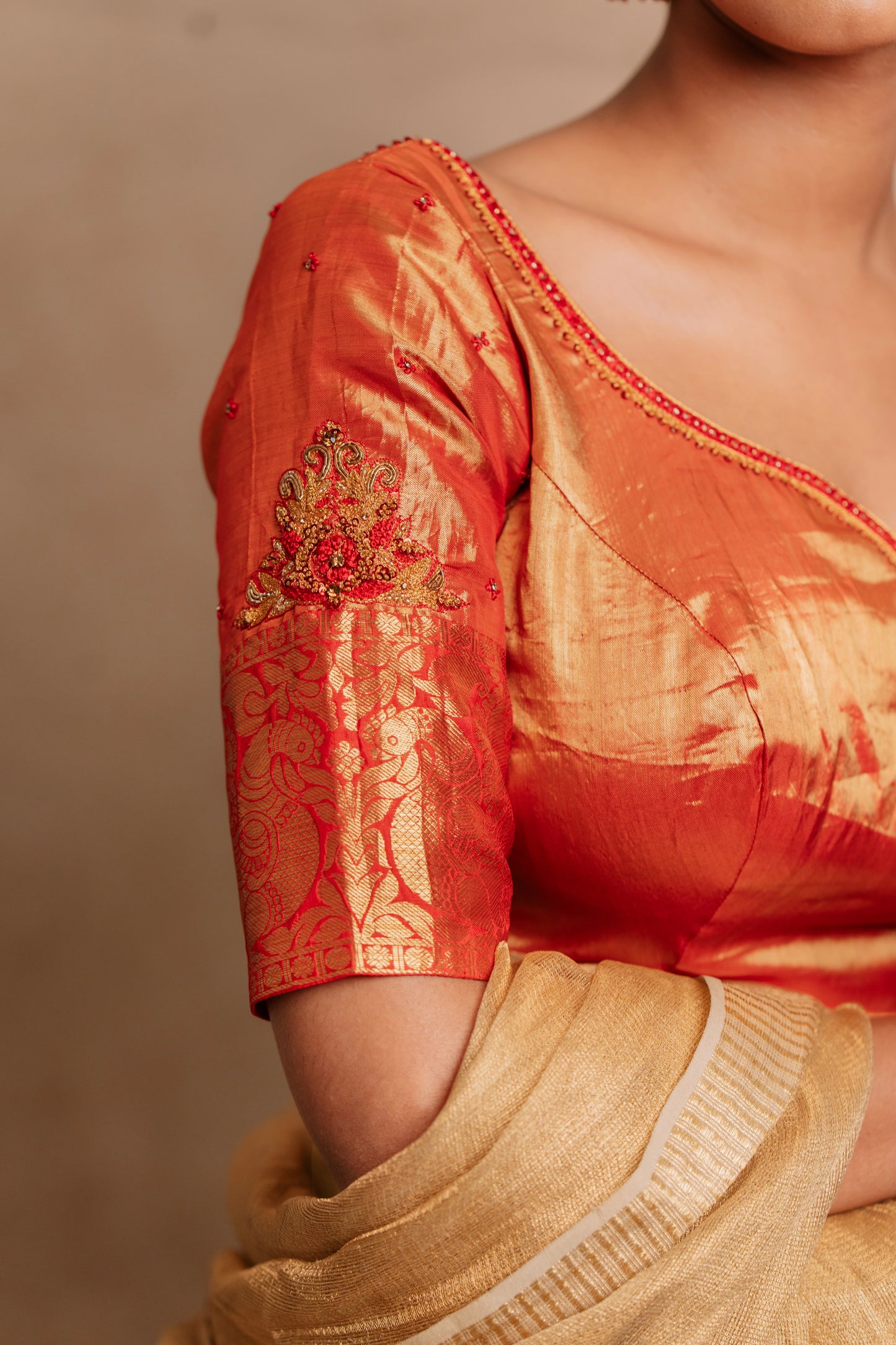 Model Premika Sekar showcasing sleeve in a hand embroidered kanjivaram tissue silk blouse in red (Dual Tone Silk) by team Akloset. Fashionable, high-quality craftsmanship that is stylish and affordable.