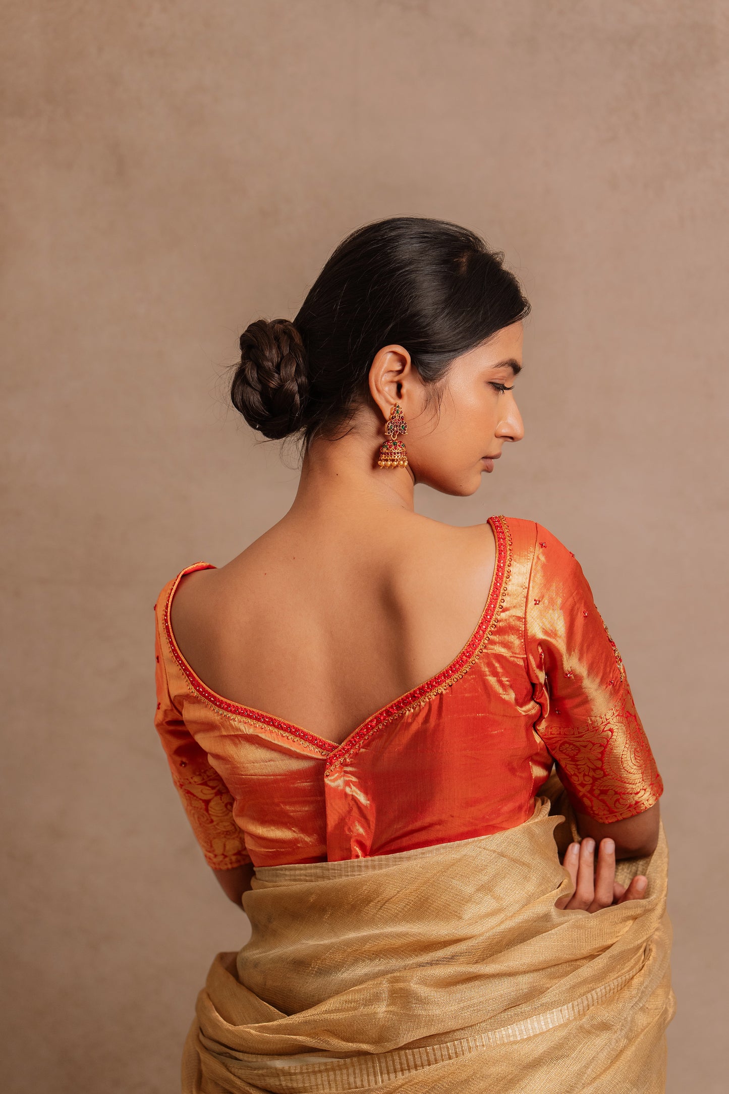 Model Premika Sekar showcasingblouse back design in a hand embroidered kanjivaram tissue silk blouse in red (Dual Tone Silk) by team Akloset. Fashionable, high-quality craftsmanship that is stylish and affordable.